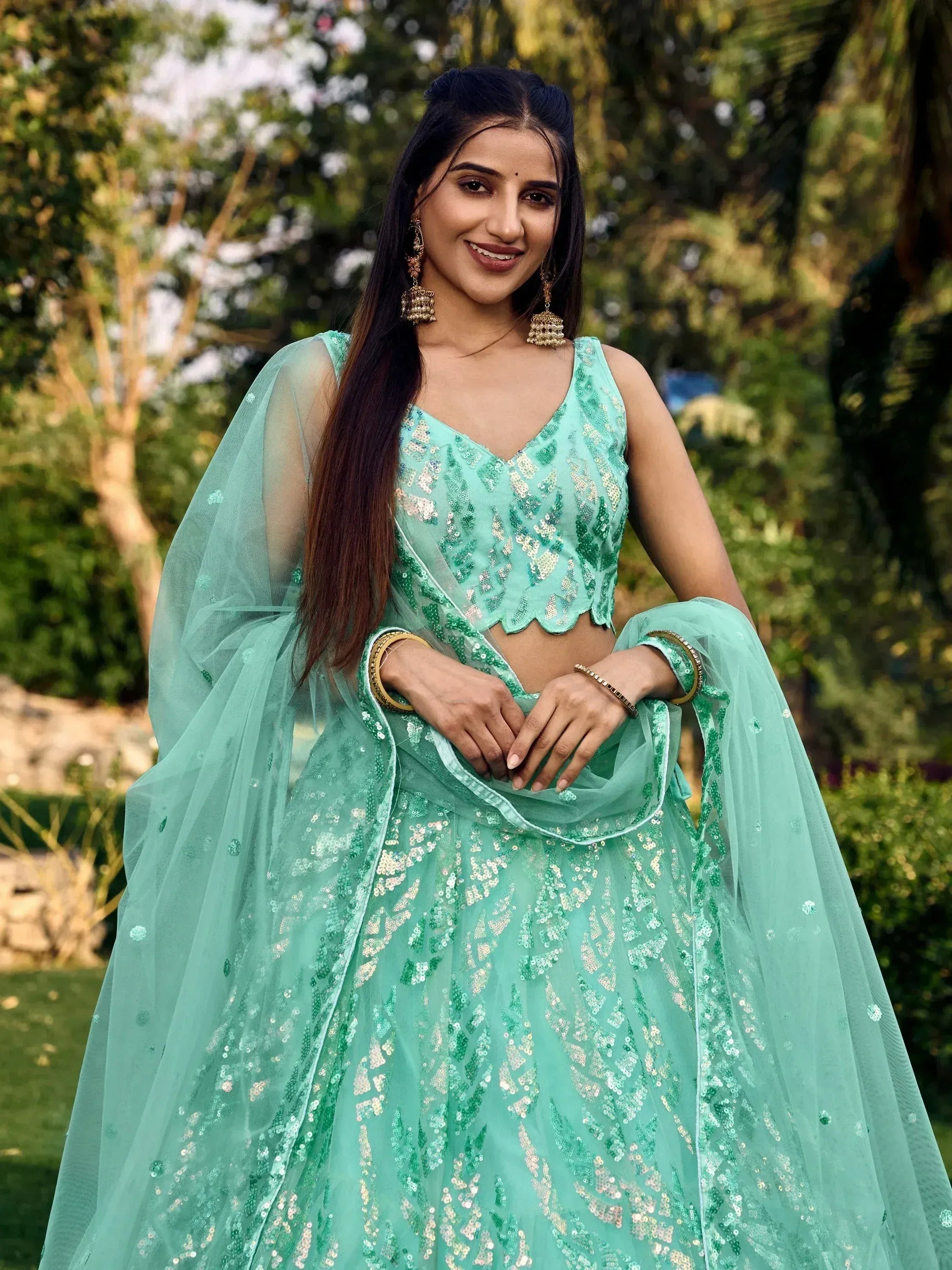 Mint green sequin lehenga choli with sheer dupatta, perfect for Indian ethnic wear and festive occasions.