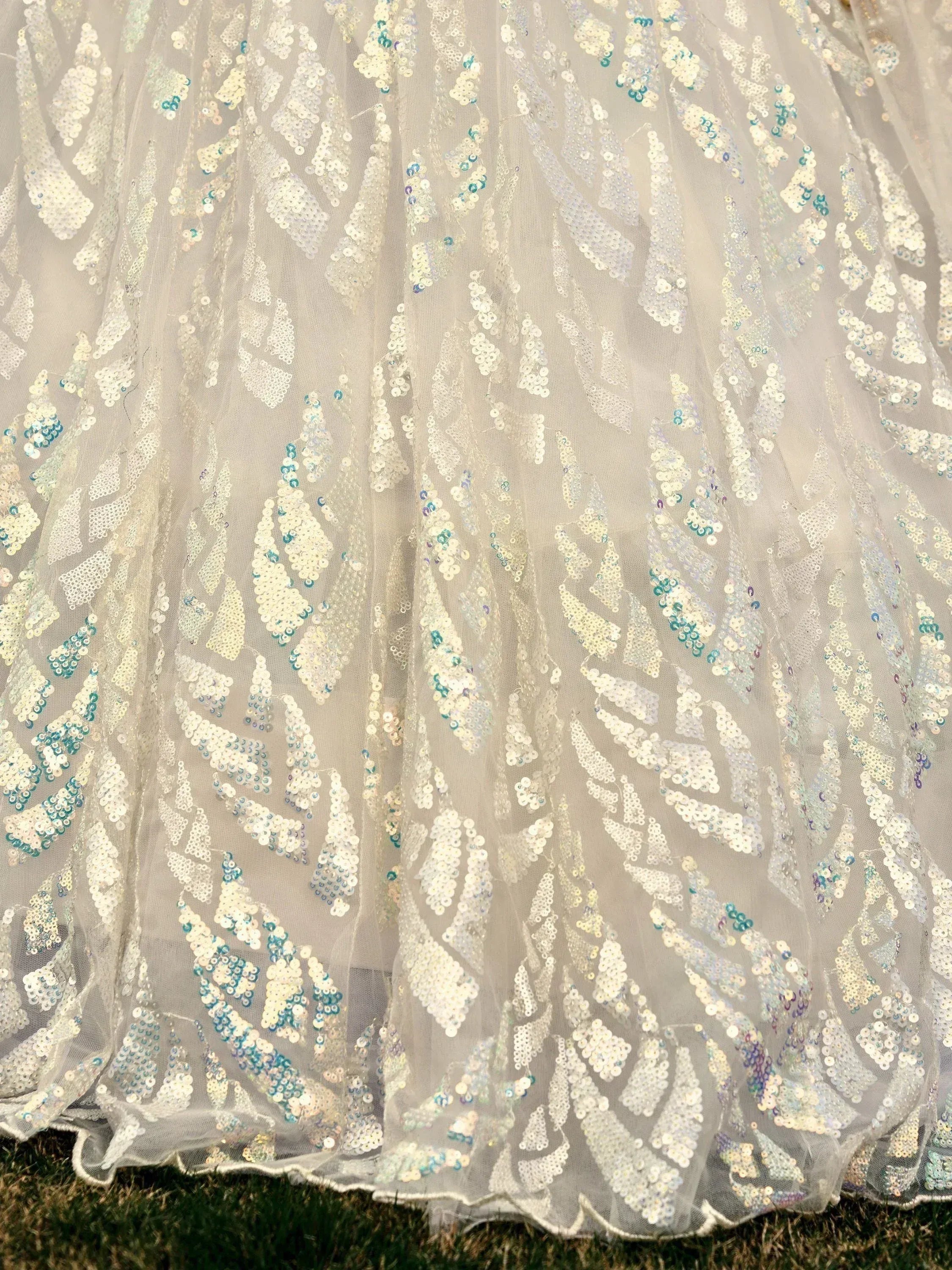 White sequin embroidered ethnic gown with blue accents, perfect for Indian weddings and festive occasions.
