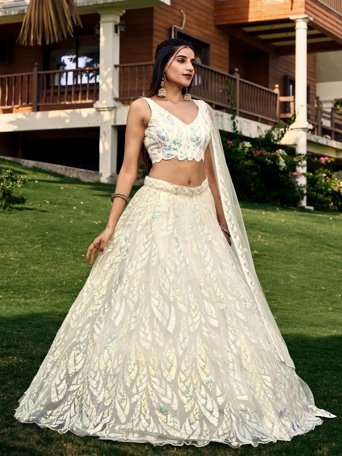 Elegant white embroidered lehenga choli with floral sequin work, perfect for Indian weddings and festive occasions.
