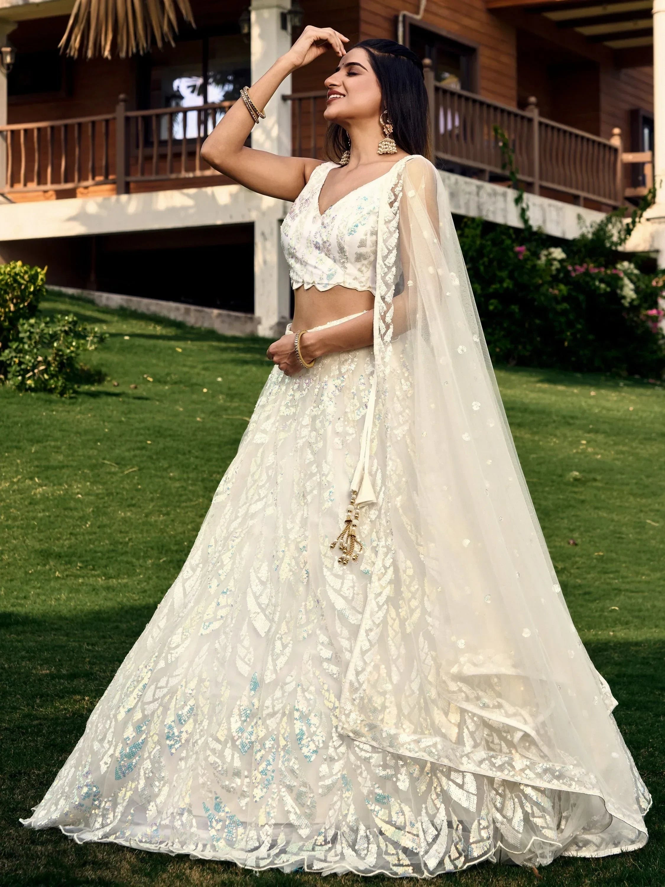 Elegant white lehenga choli with sequin embroidery, sheer dupatta, perfect for Indian weddings or festive occasions