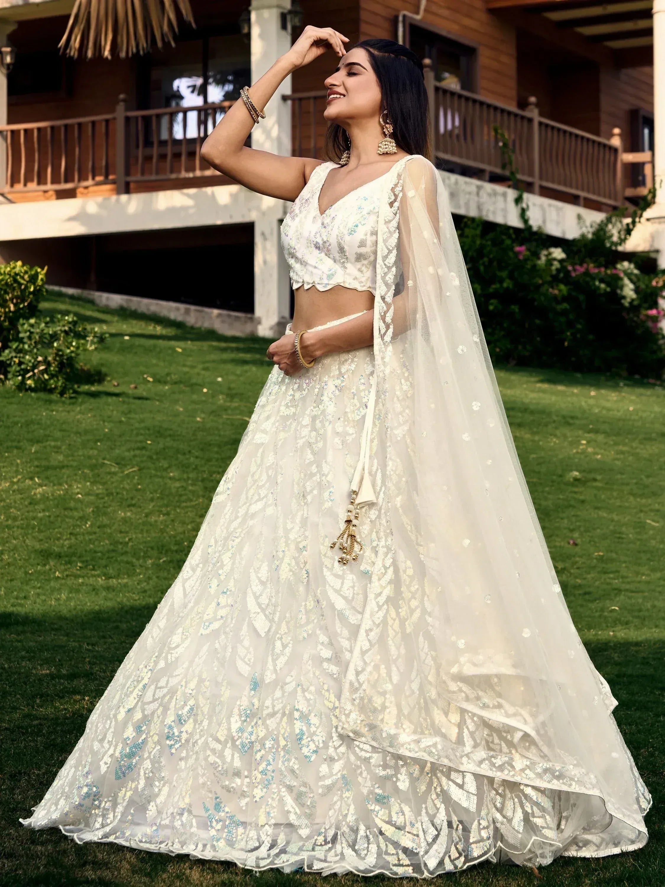 Elegant white lehenga choli with sequin embroidery, sheer dupatta, perfect for Indian weddings or festive occasions