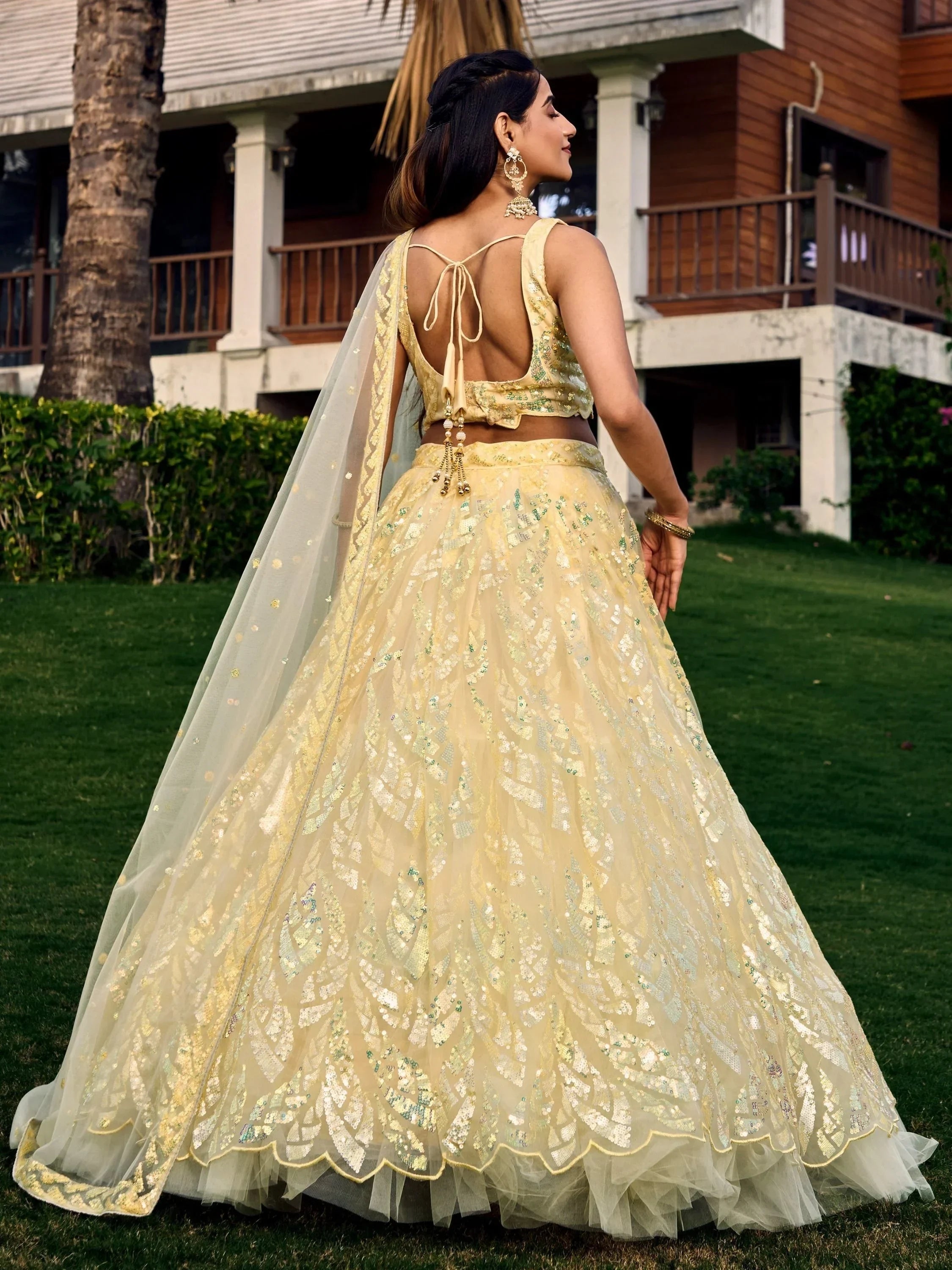 Elegant yellow lehenga choli with sequin embroidery, back view, perfect for Indian weddings and festive occasions