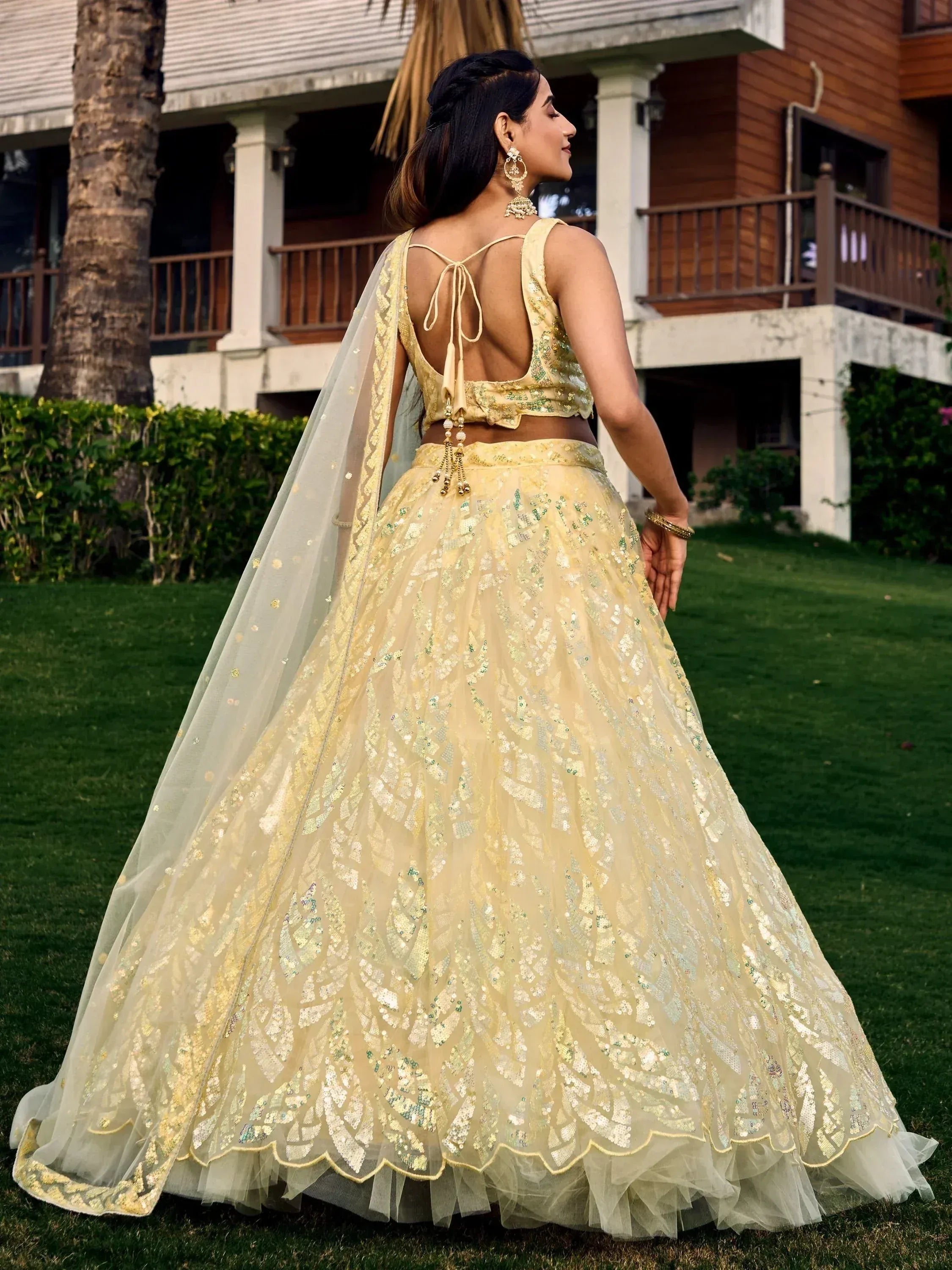 Elegant yellow lehenga choli with sequin embroidery, back view, perfect for Indian weddings and festive occasions