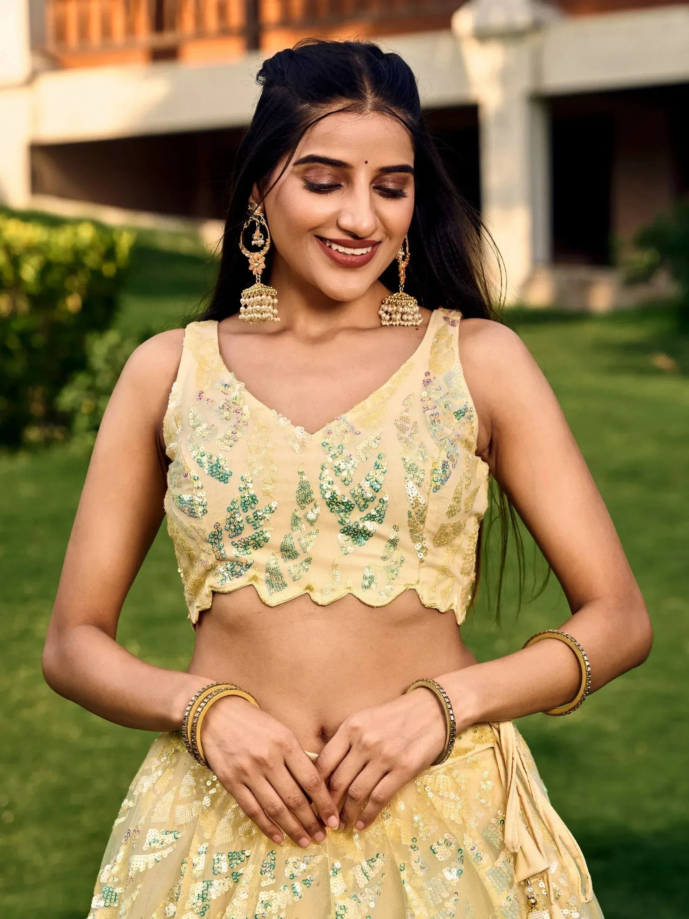 Yellow sequin lehenga choli with green embroidery, perfect for Indian ethnic wear and festive occasions.