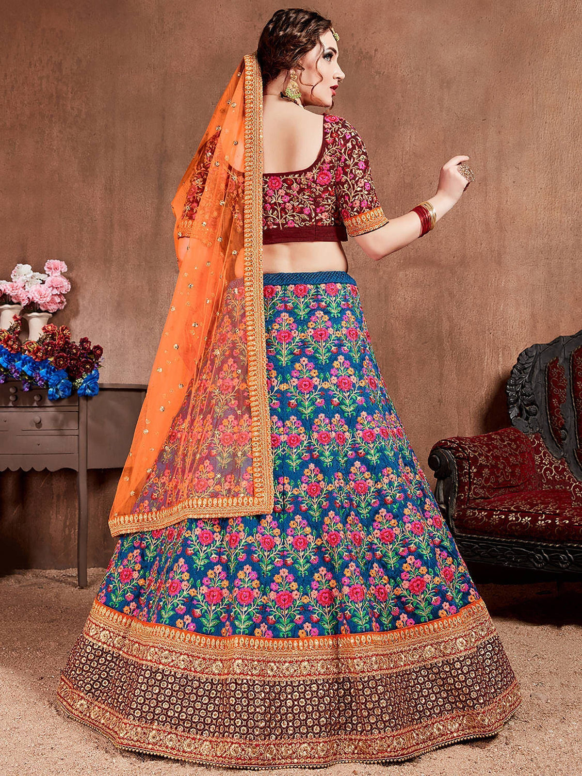 Designer lehenga choli with floral embroidery, orange dupatta, and blue skirt for Indian ethnic wear