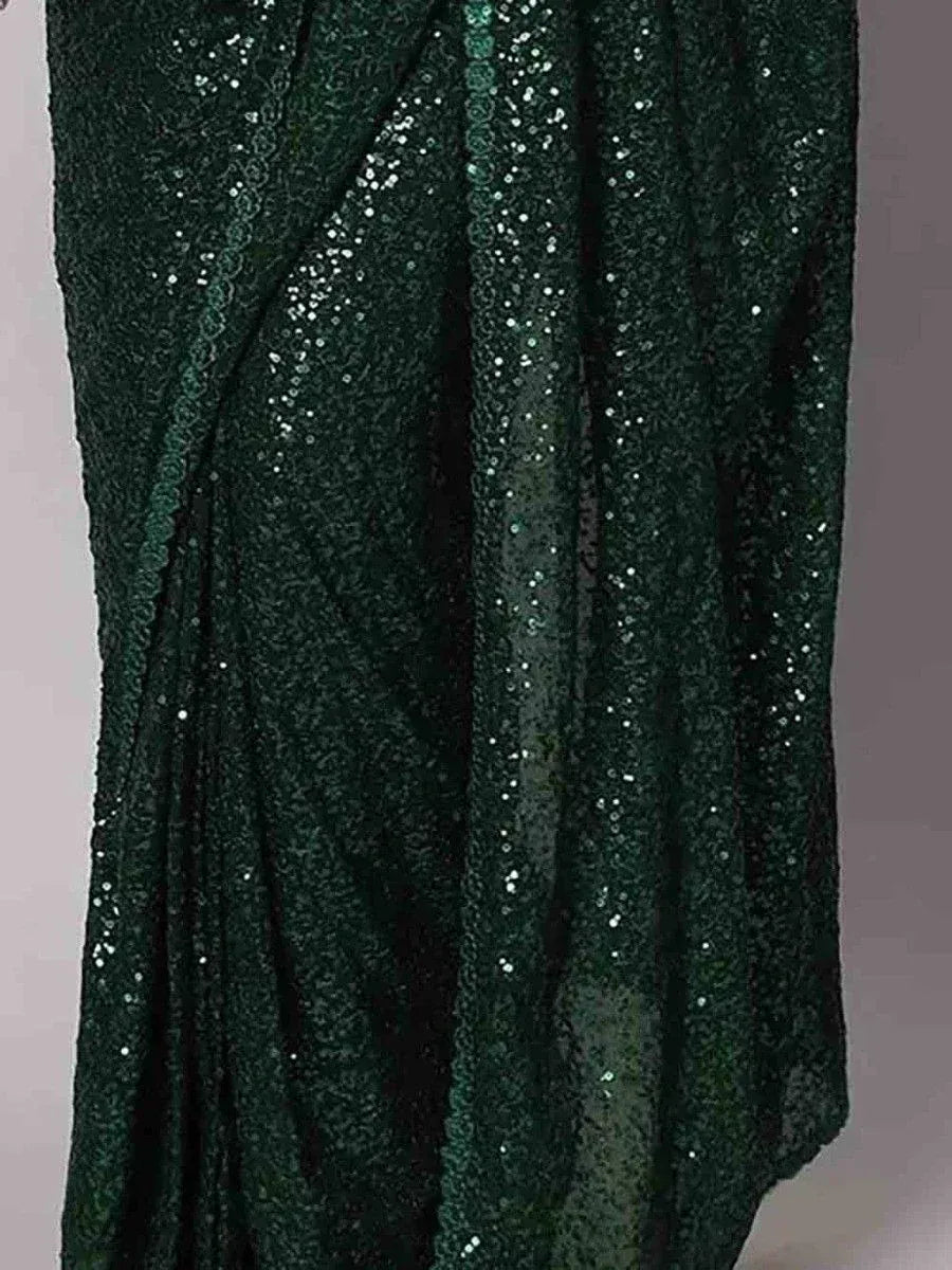Emerald green sequin saree with shimmering embellishments, perfect for festive occasions.