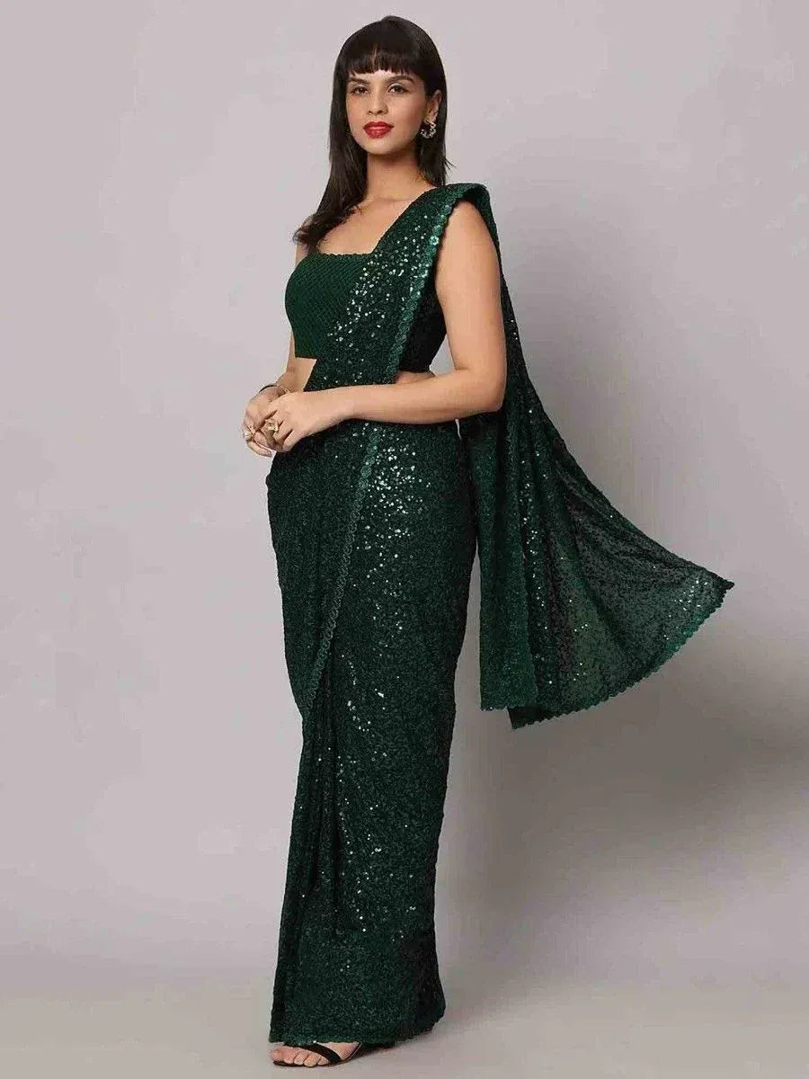 Emerald green sequin saree with sleeveless blouse, perfect for Indian ethnic events and festive occasions.