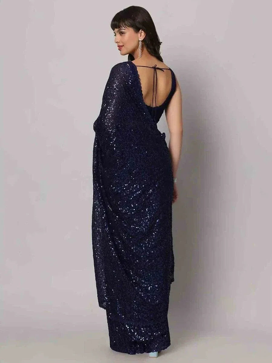 Navy blue sequin saree with open back and tie detail, elegant ethnic wear for parties