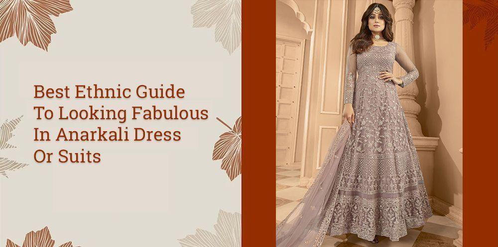 Woman wearing embroidered Anarkali suit, Indian ethnic gown, in elegant indoor setting