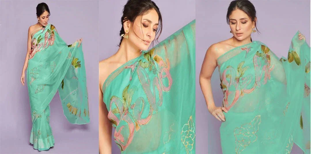 Woman in pastel green designer saree with floral prints and sheer fabric, elegant ethnic wear