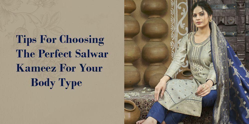 Woman wearing embroidered salwar kameez with dupatta, seated in ethnic setting