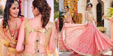 Women in traditional Indian attire wearing pink and gold designer lehengas at a festive event