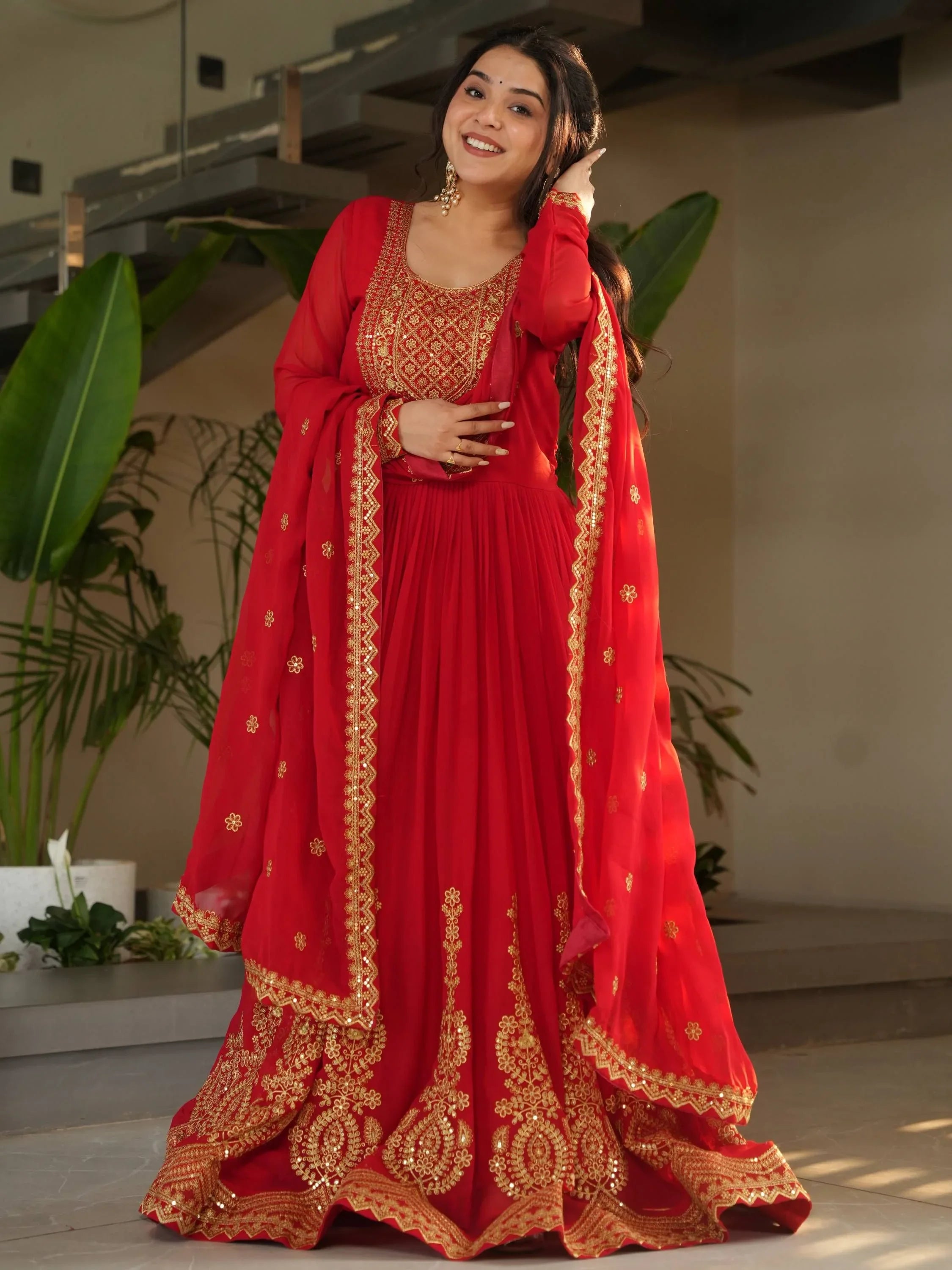 Woman in red and gold embroidered ethnic gown, ideal for bridesmaid or evening wear