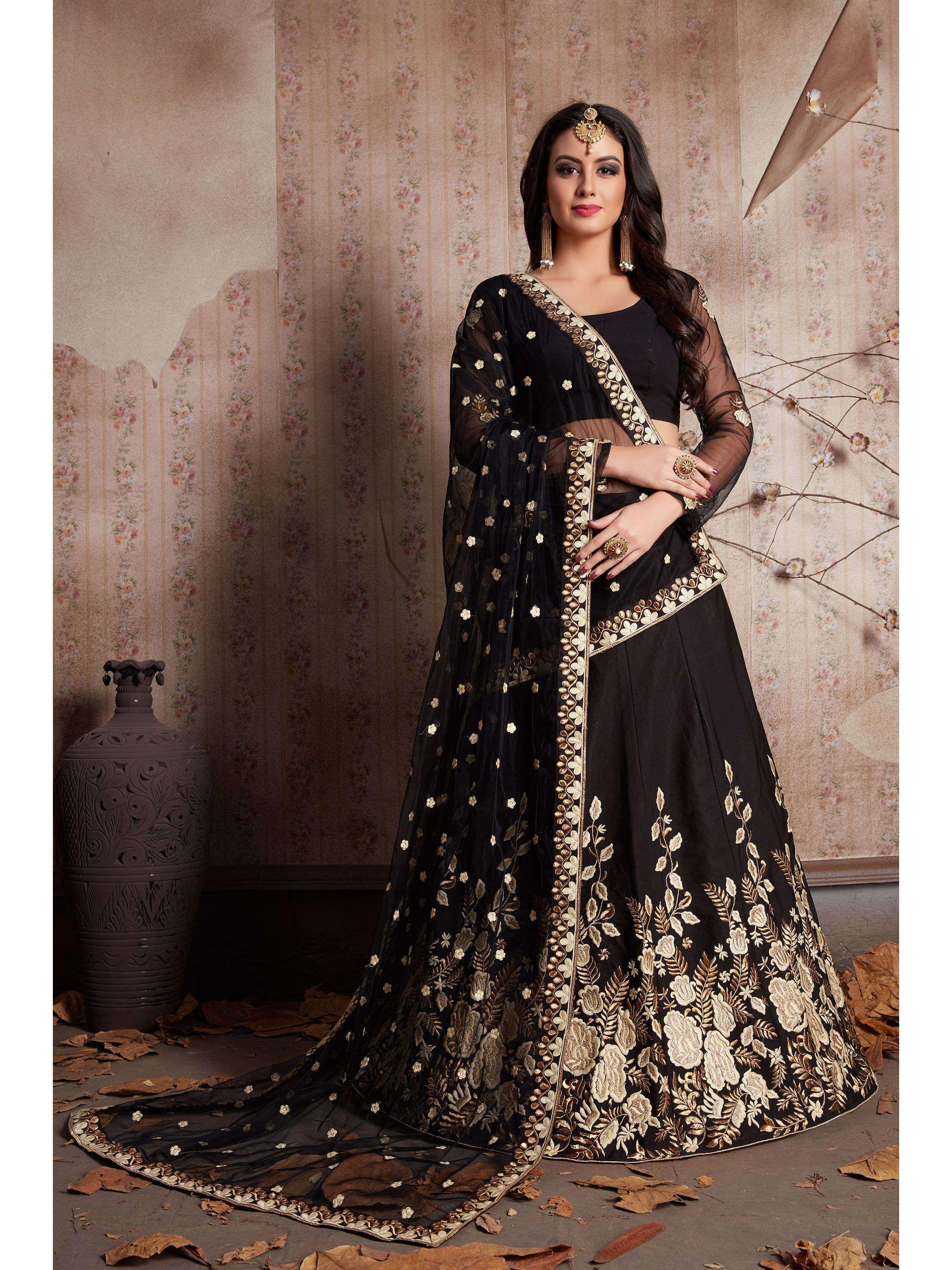 Woman wearing black embroidered lehenga choli with net dupatta and gold floral design