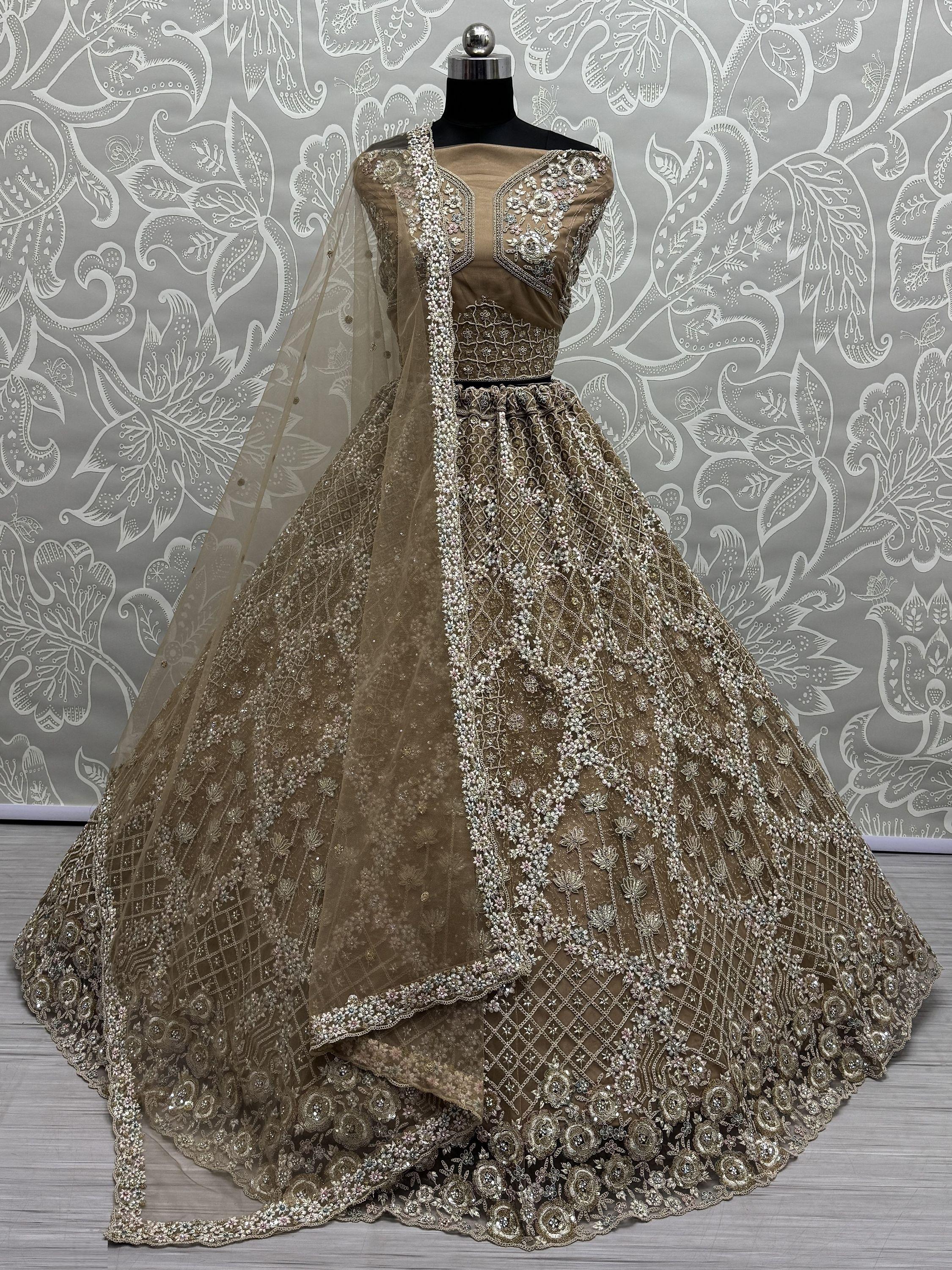 Golden bridal lehenga choli with intricate embroidery and net dupatta on mannequin