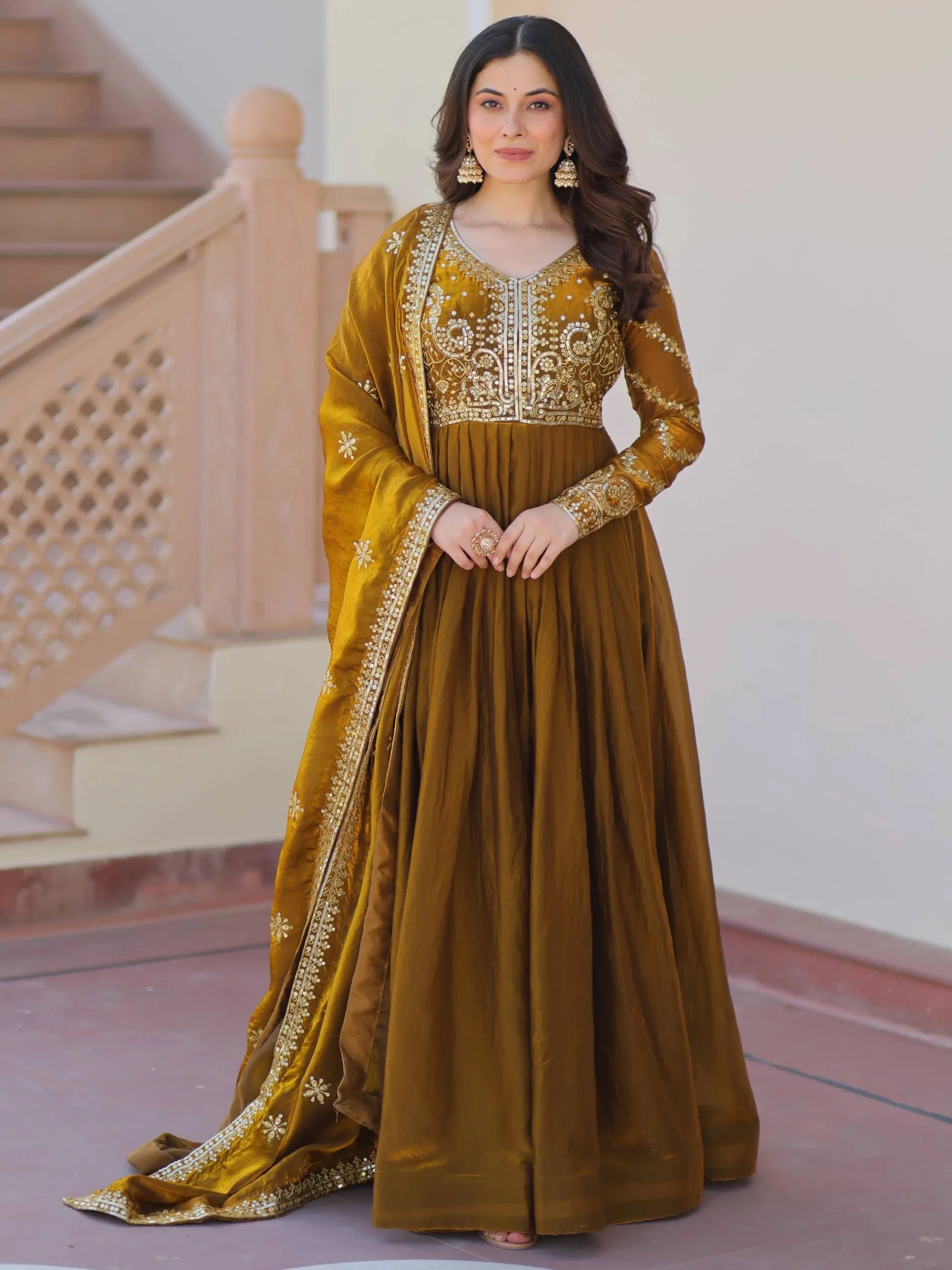 Woman wearing an embroidered brown mehendi gown with matching dupatta, ethnic Indian fashion