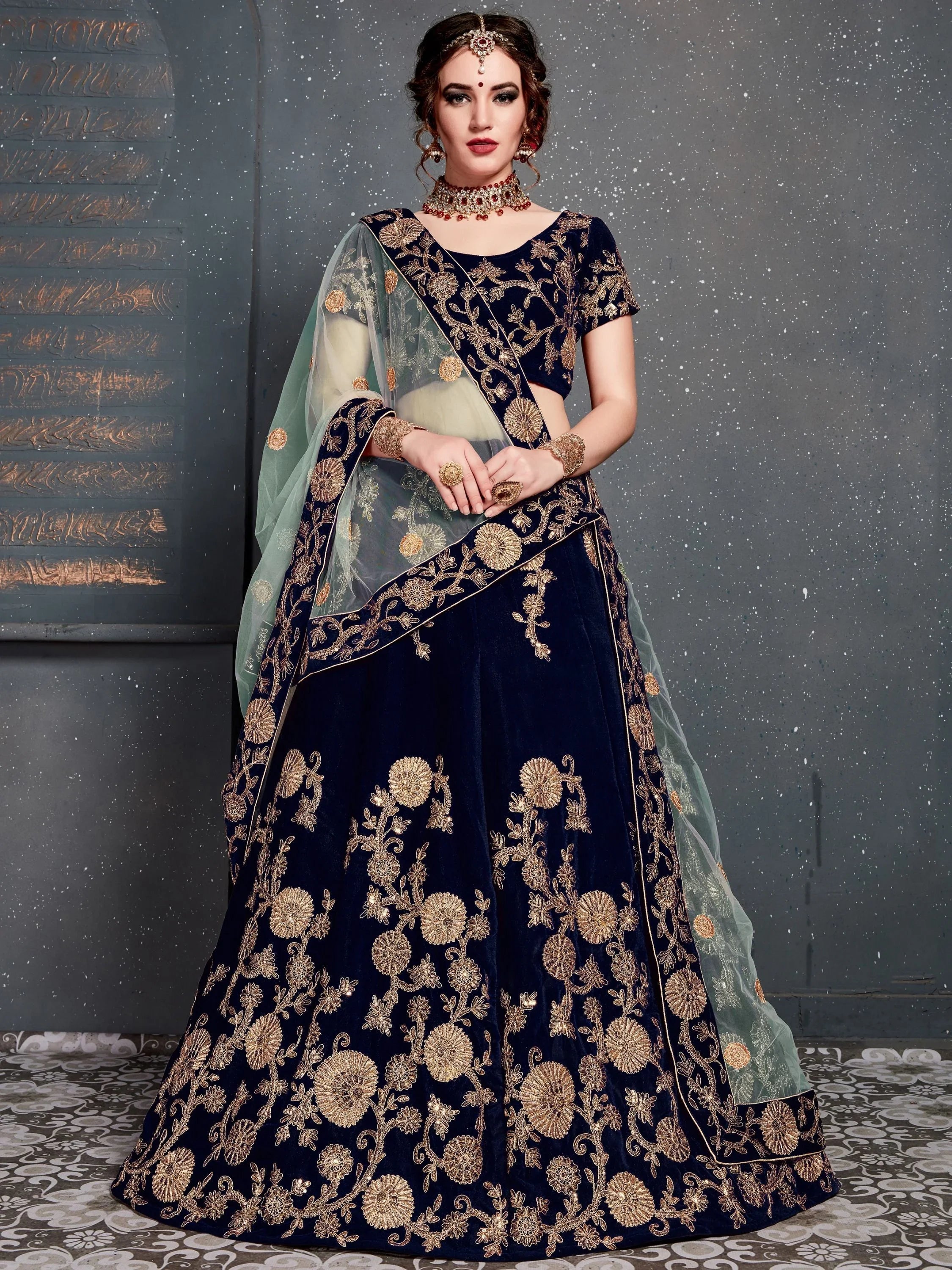 Navy blue bridal lehenga choli with gold embroidery and sheer dupatta, traditional Indian attire