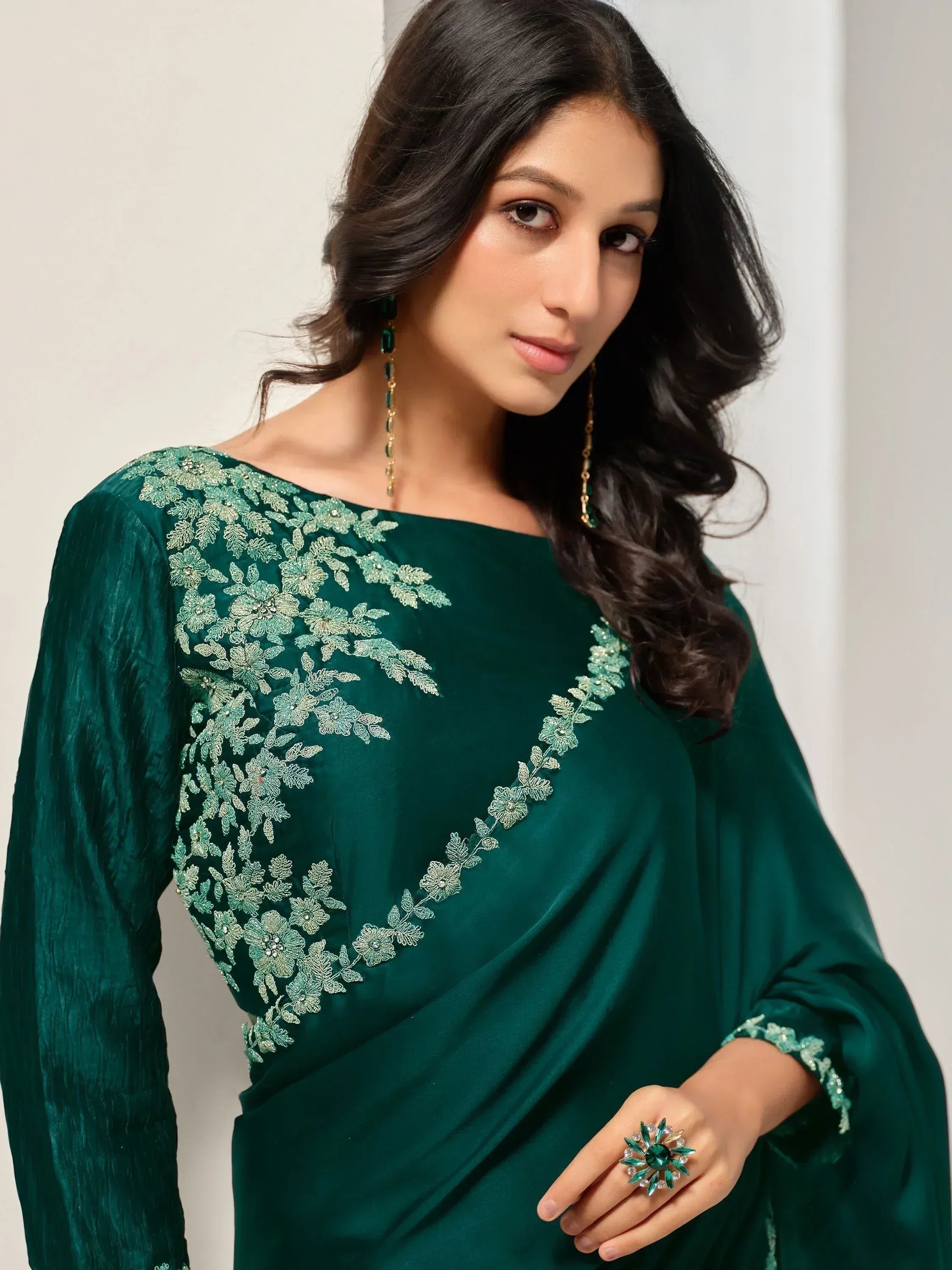 Emerald green ethnic gown with floral embroidery, perfect for Indian occasions and festive wear.