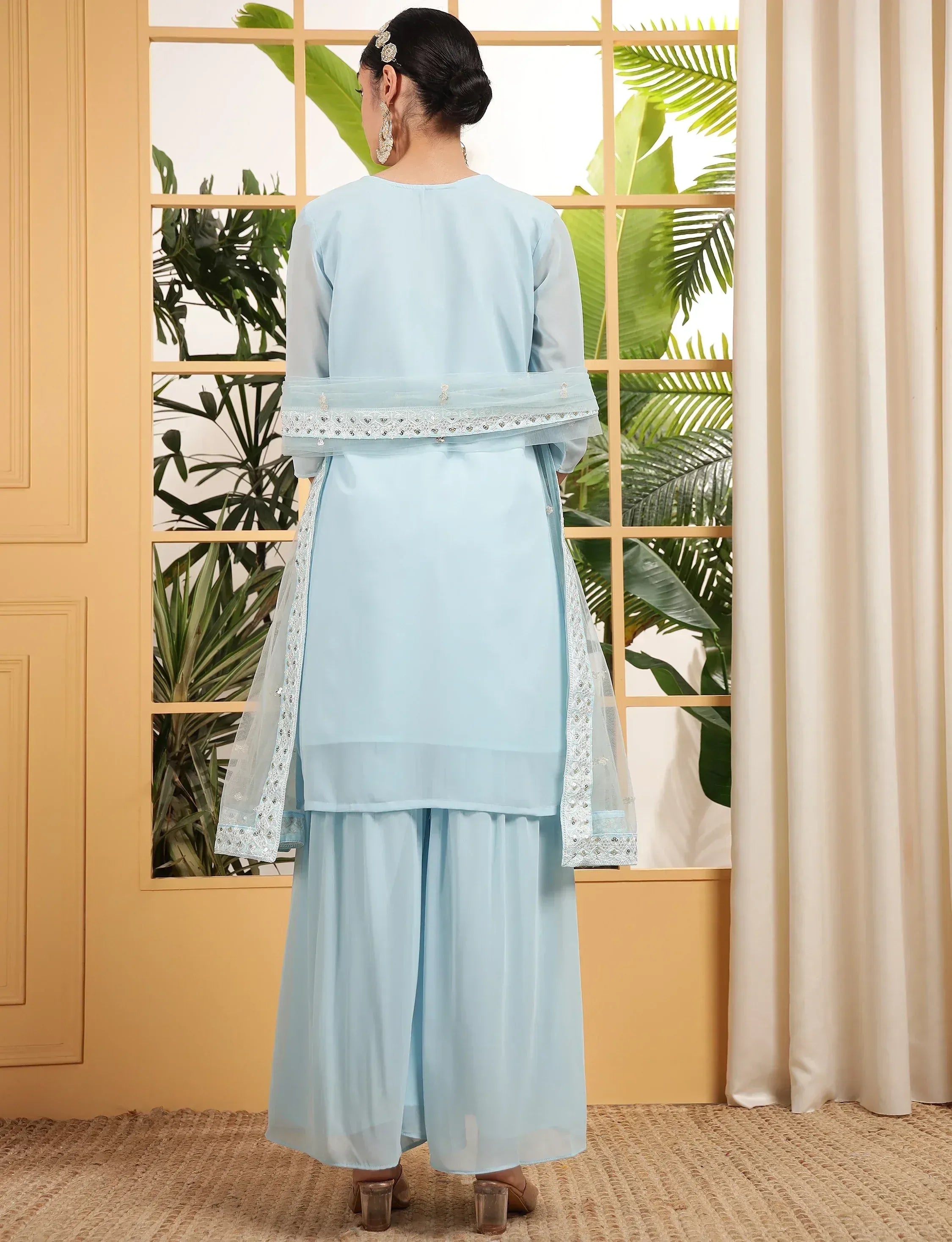 Light blue ethnic salwar kameez with embroidered dupatta, back view