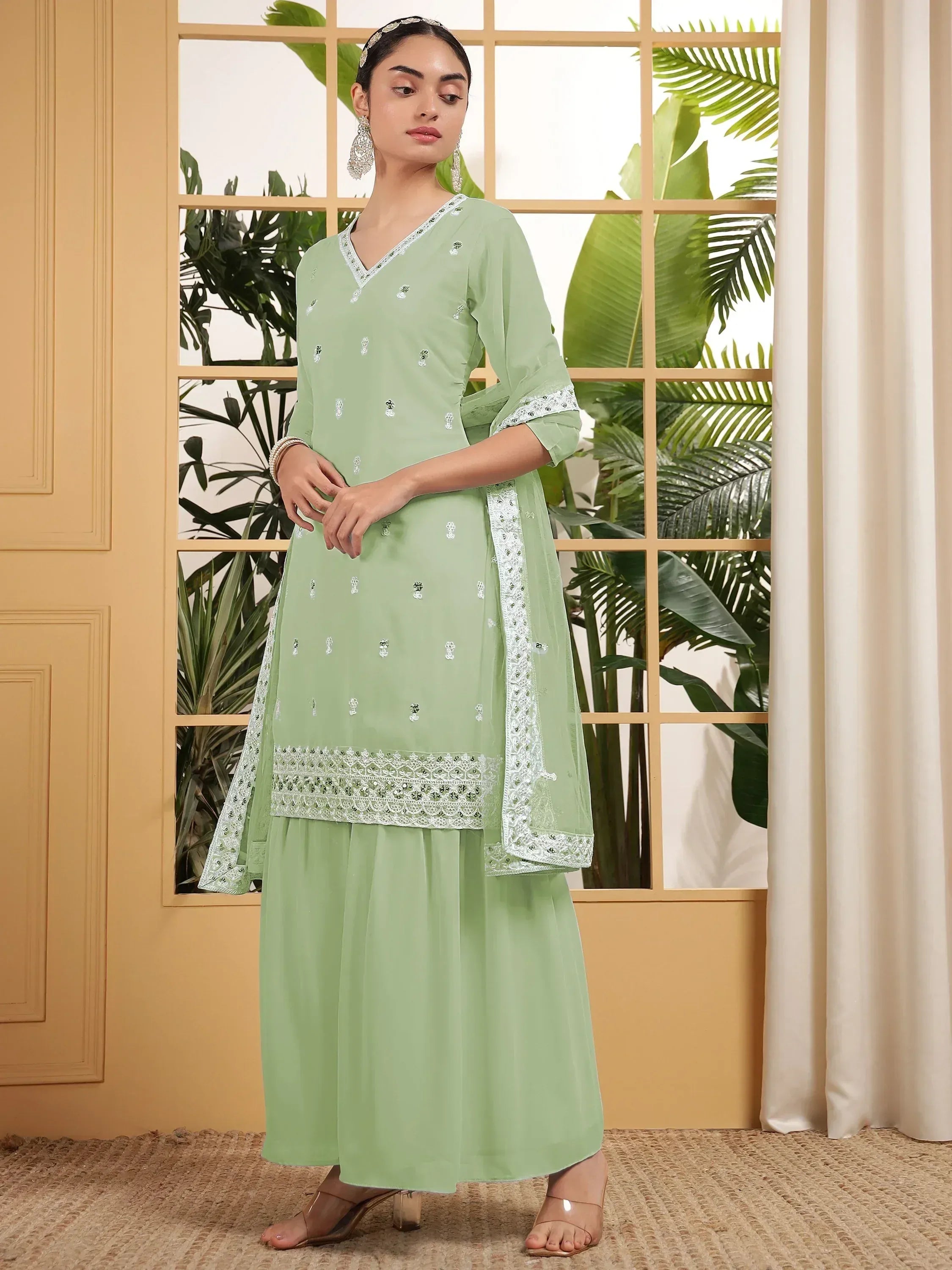 Mint green embroidered salwar kameez with lace detailing, perfect for ethnic occasions