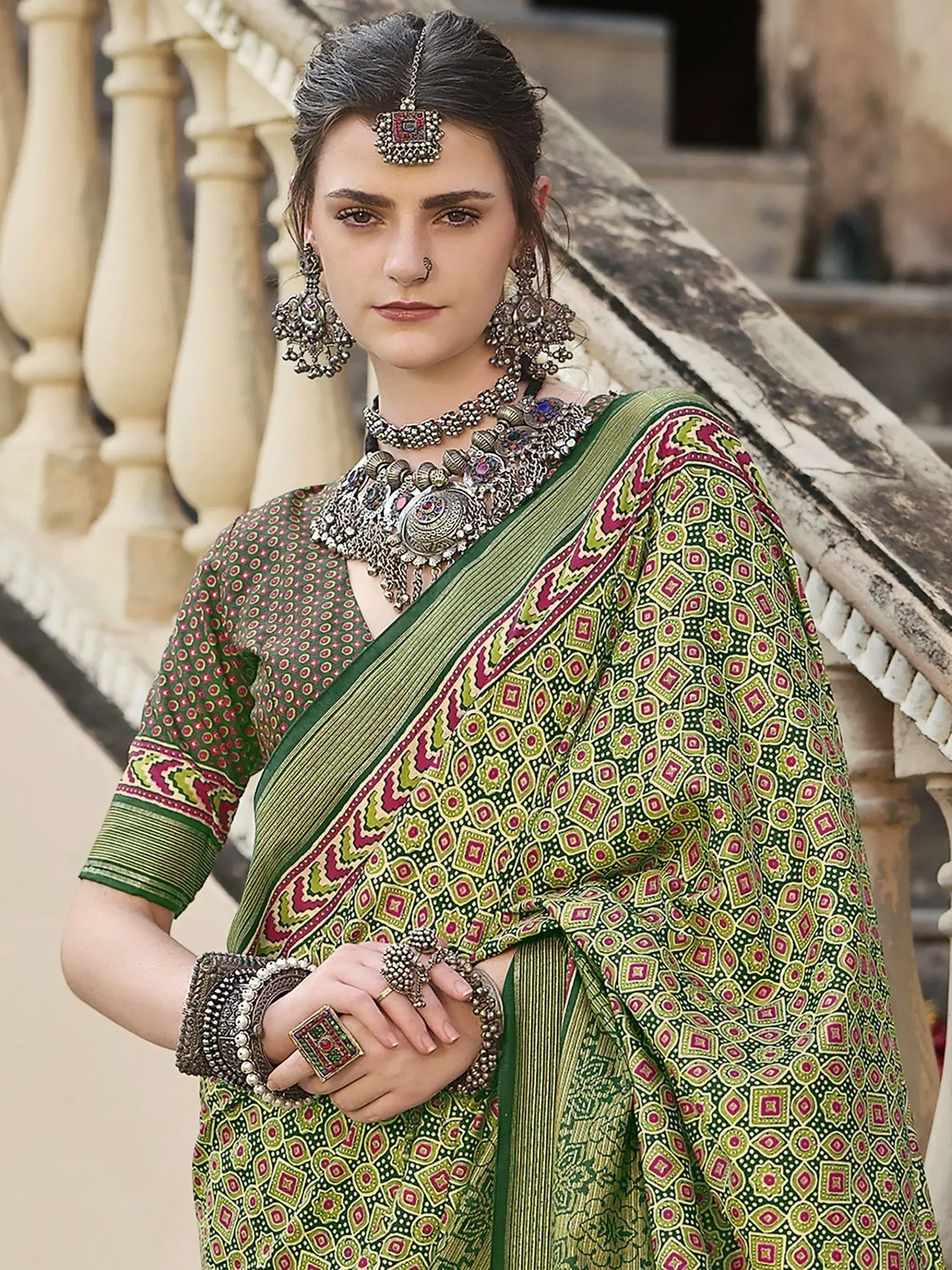 Green printed saree with ethnic jewelry, traditional Indian wear for festive occasions