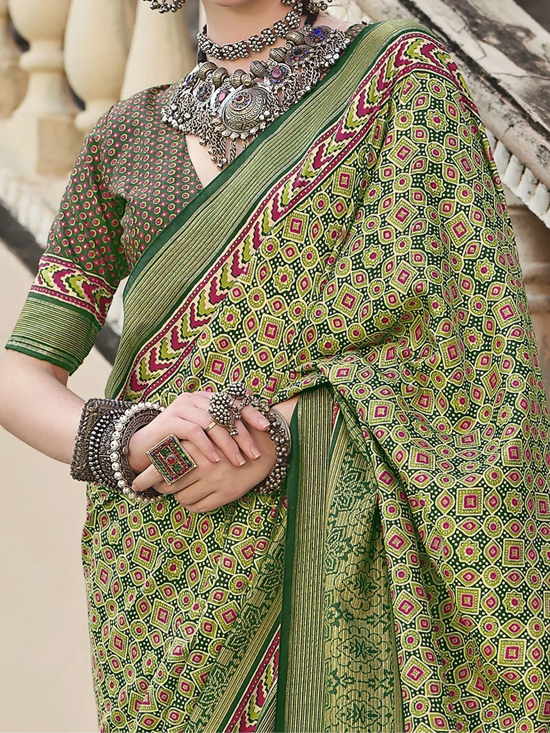 Green printed saree with ethnic jewelry, perfect for Indian festive wear and traditional occasions.