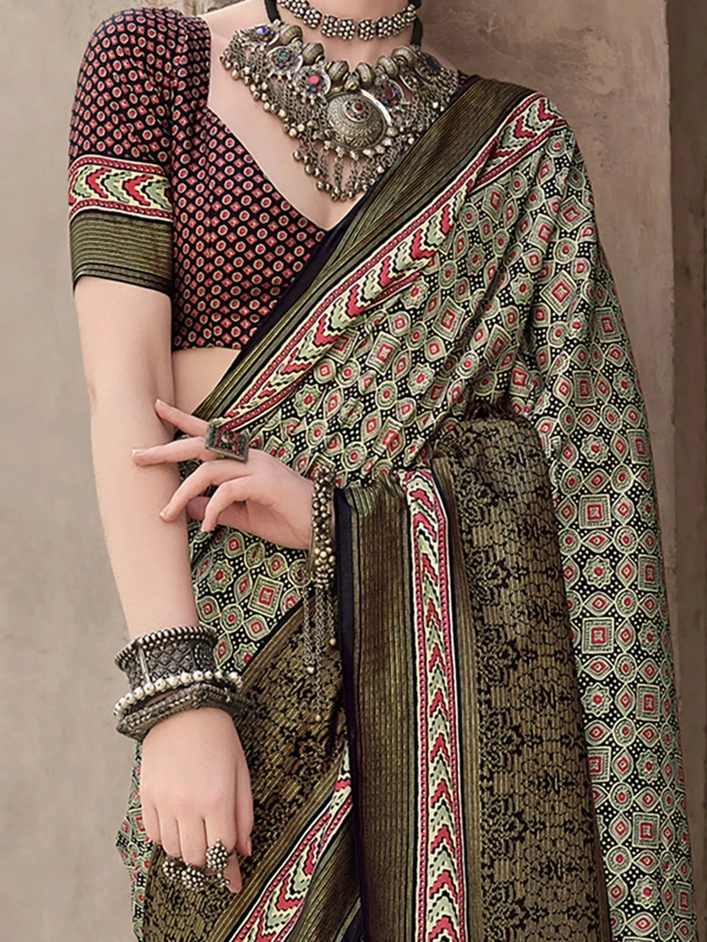 Elegant Indian saree with geometric print, paired with statement jewelry and a matching blouse.