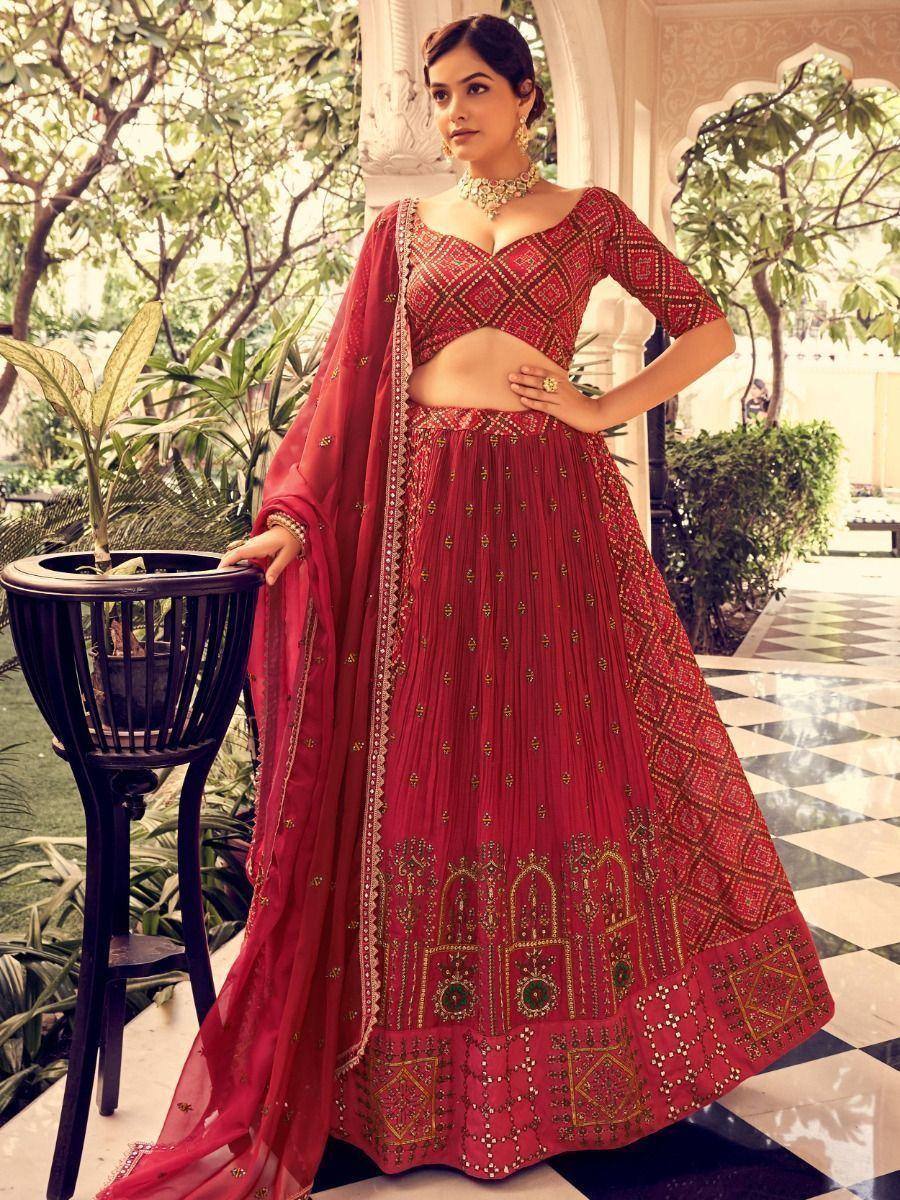 Red embroidered lehenga choli with gold detailing, perfect for Indian weddings and festive occasions.