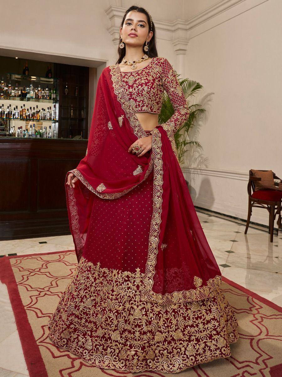 Red and gold embroidered lehenga choli with intricate detailing, perfect for Indian weddings and festive occasions.