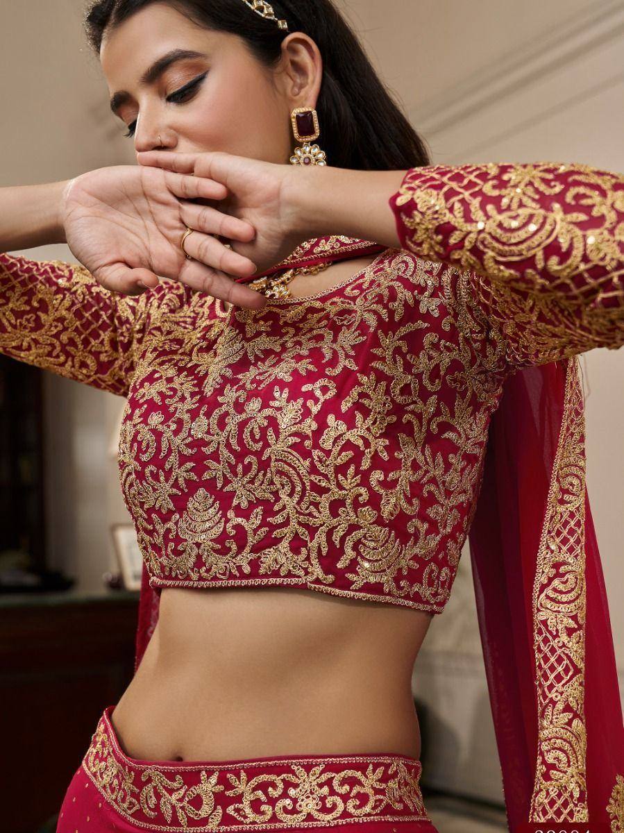 Red and gold embroidered lehenga choli with intricate zari work, perfect for Indian ethnic wear