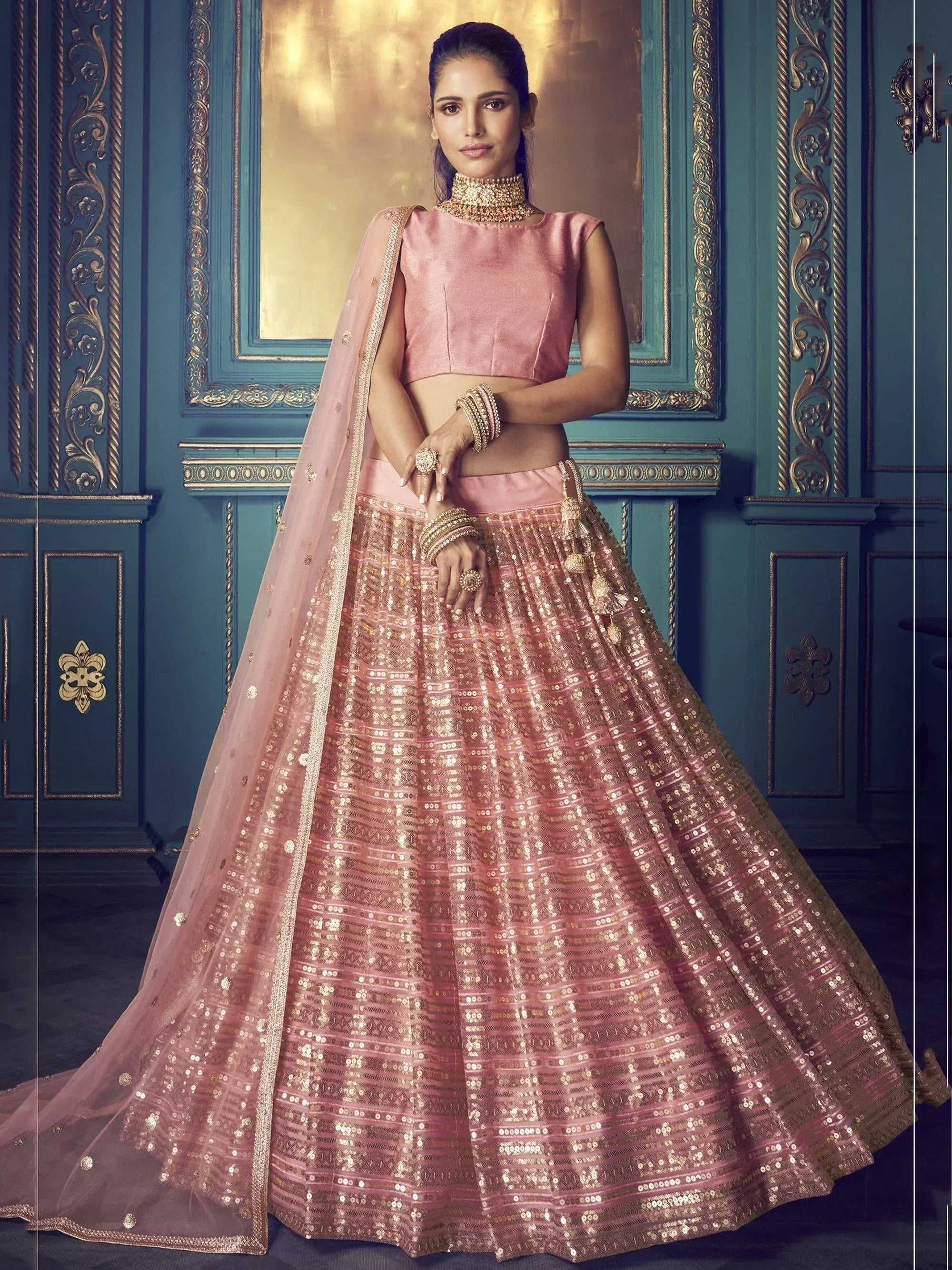 Pink sequin lehenga choli with gold embroidery, perfect for Indian weddings and festive occasions.