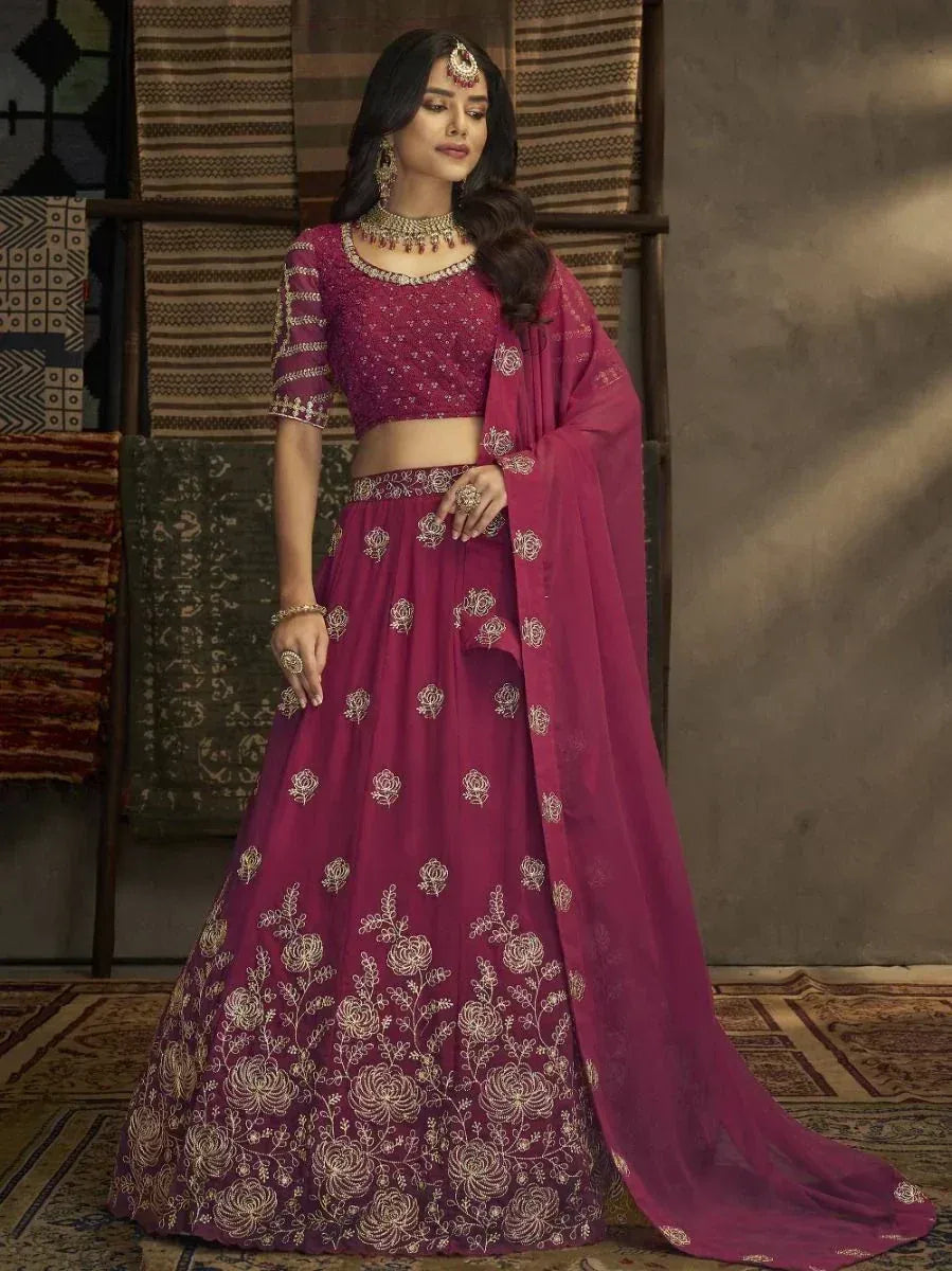 Elegant maroon lehenga choli with gold floral embroidery, perfect for Indian weddings and festive occasions.
