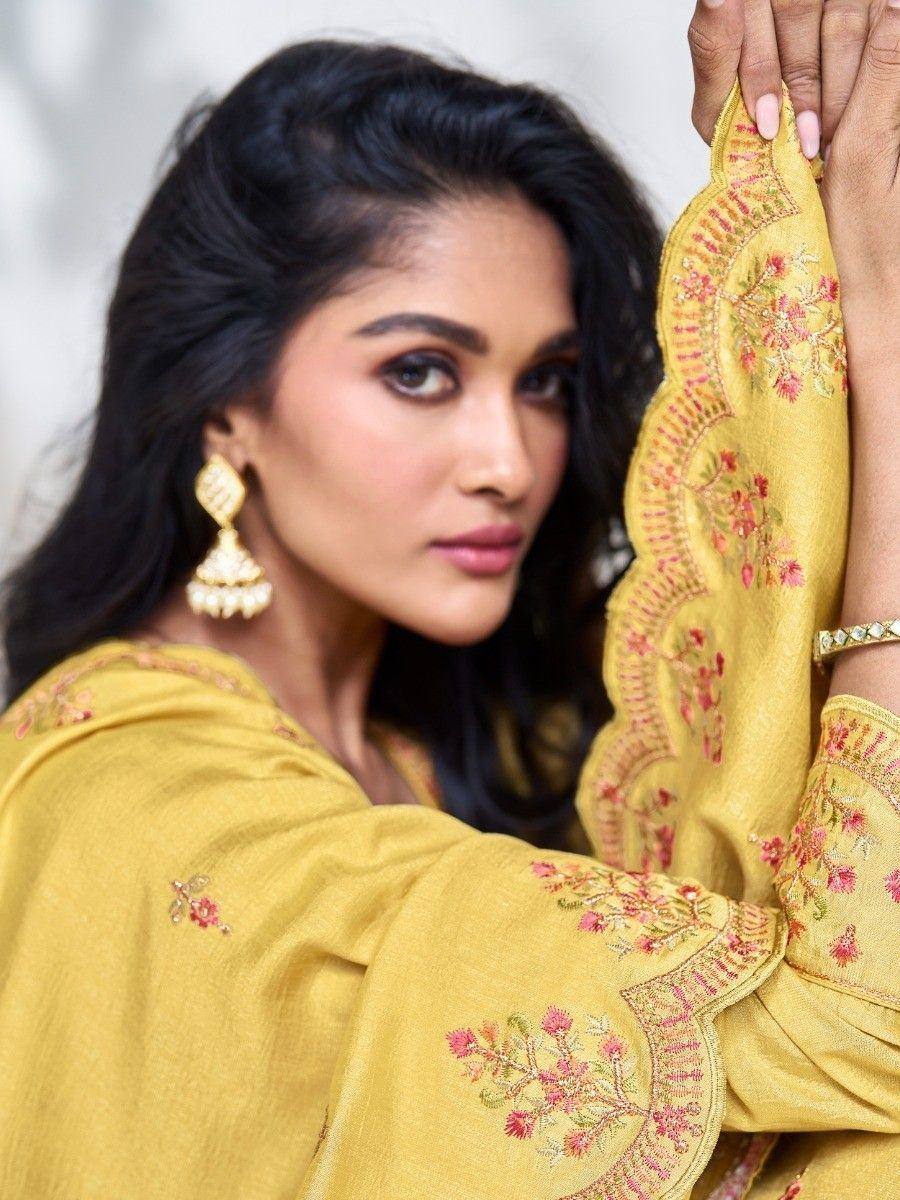 Yellow embroidered ethnic salwar kameez with floral detailing and gold jhumka earrings