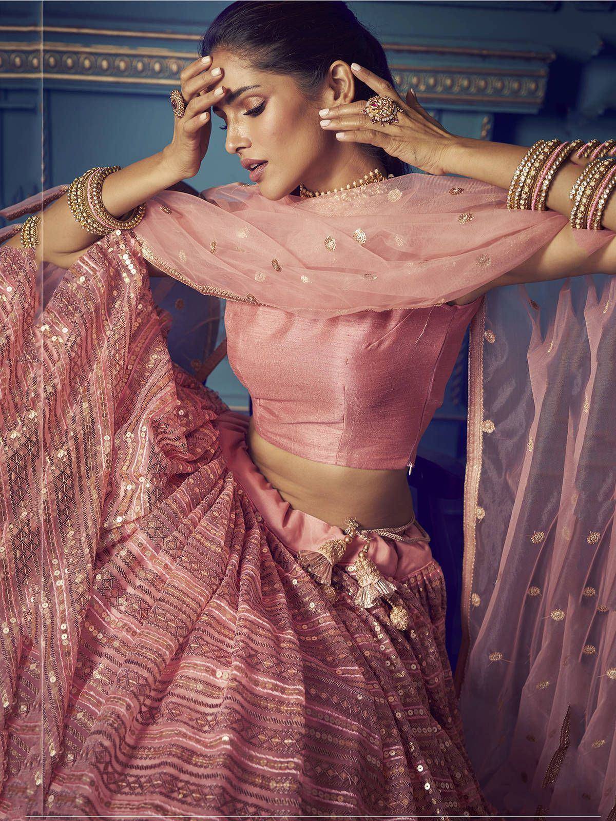 Pink designer lehenga choli with gold embroidery and sheer dupatta, perfect for Indian weddings and festive occasions