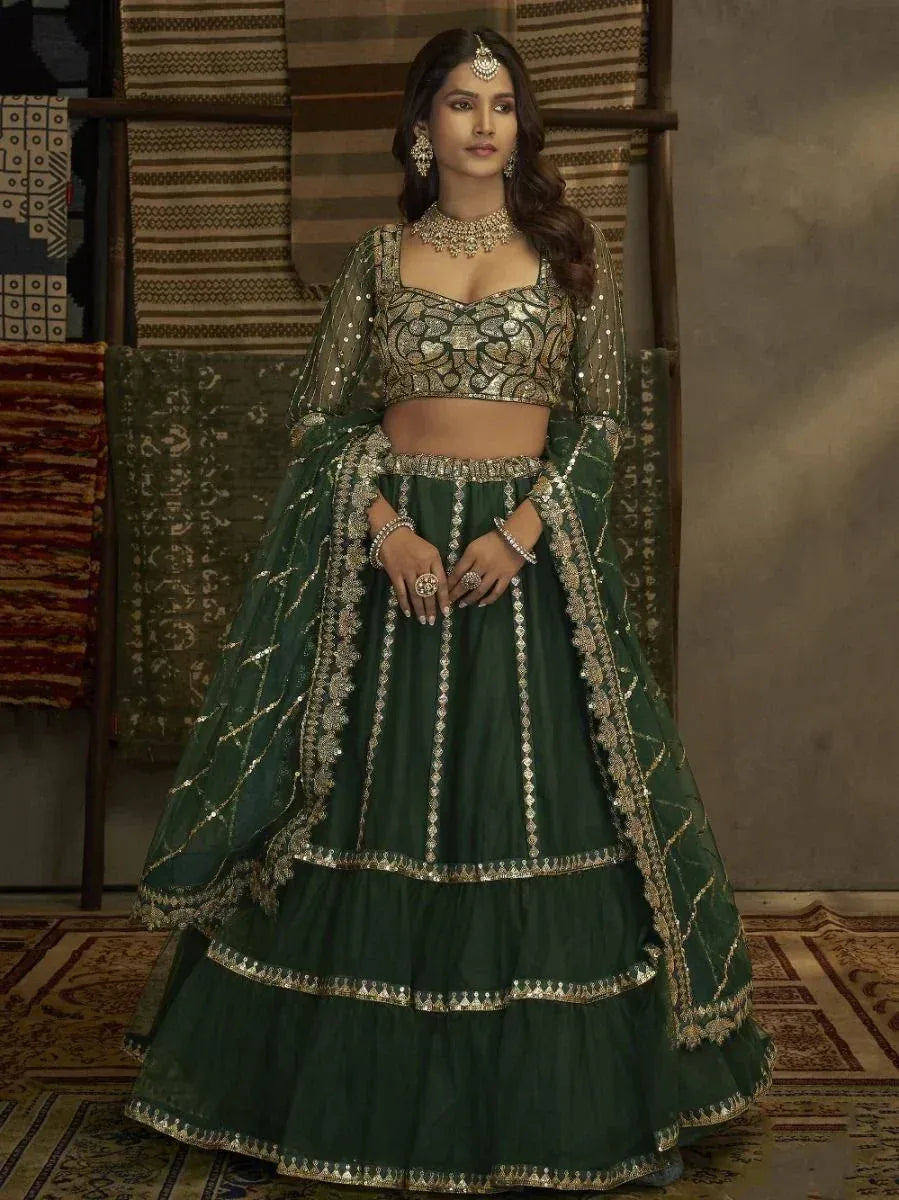 Emerald green designer lehenga choli with gold embroidery and sheer dupatta, perfect for weddings and festivals