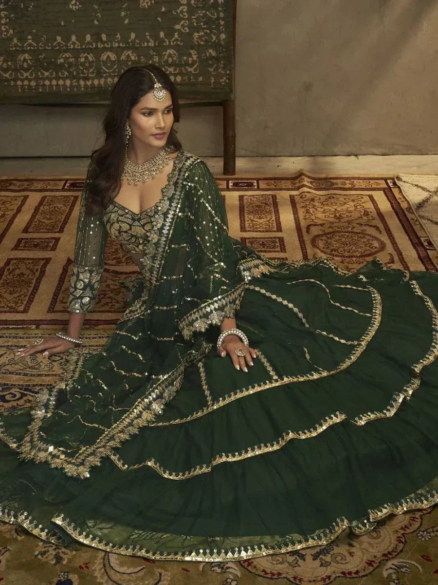 Elegant green designer lehenga choli with gold embroidery, perfect for Indian ethnic wear occasions.