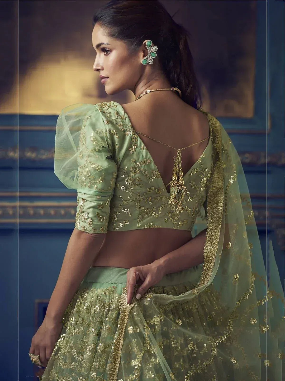 Mint green designer lehenga choli with gold embroidery, puff sleeves, and backless blouse for Indian ethnic wear