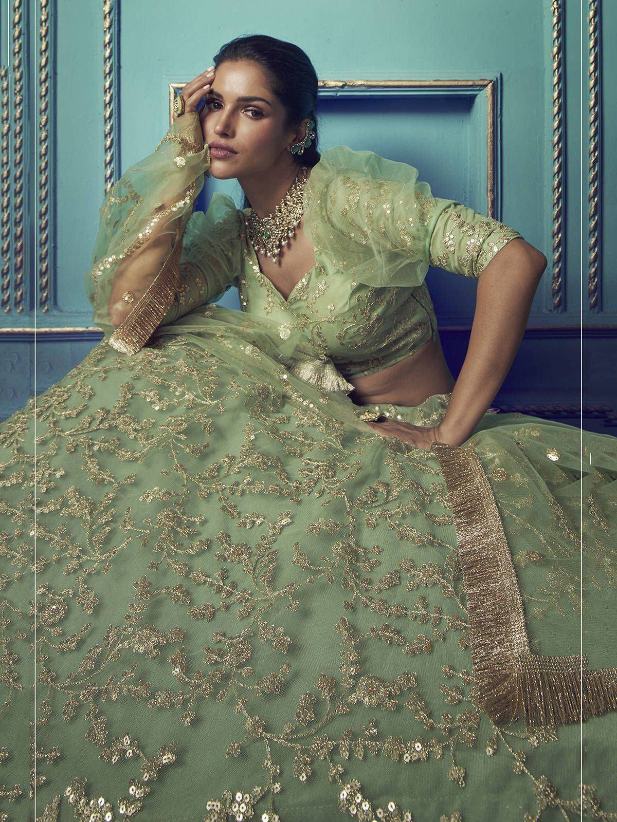 Elegant mint green lehenga choli with gold embroidery, perfect for Indian weddings and festive occasions.