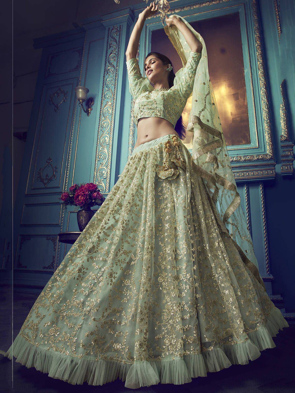 Mint green designer lehenga choli with gold embroidery, perfect for Indian weddings and festive occasions.