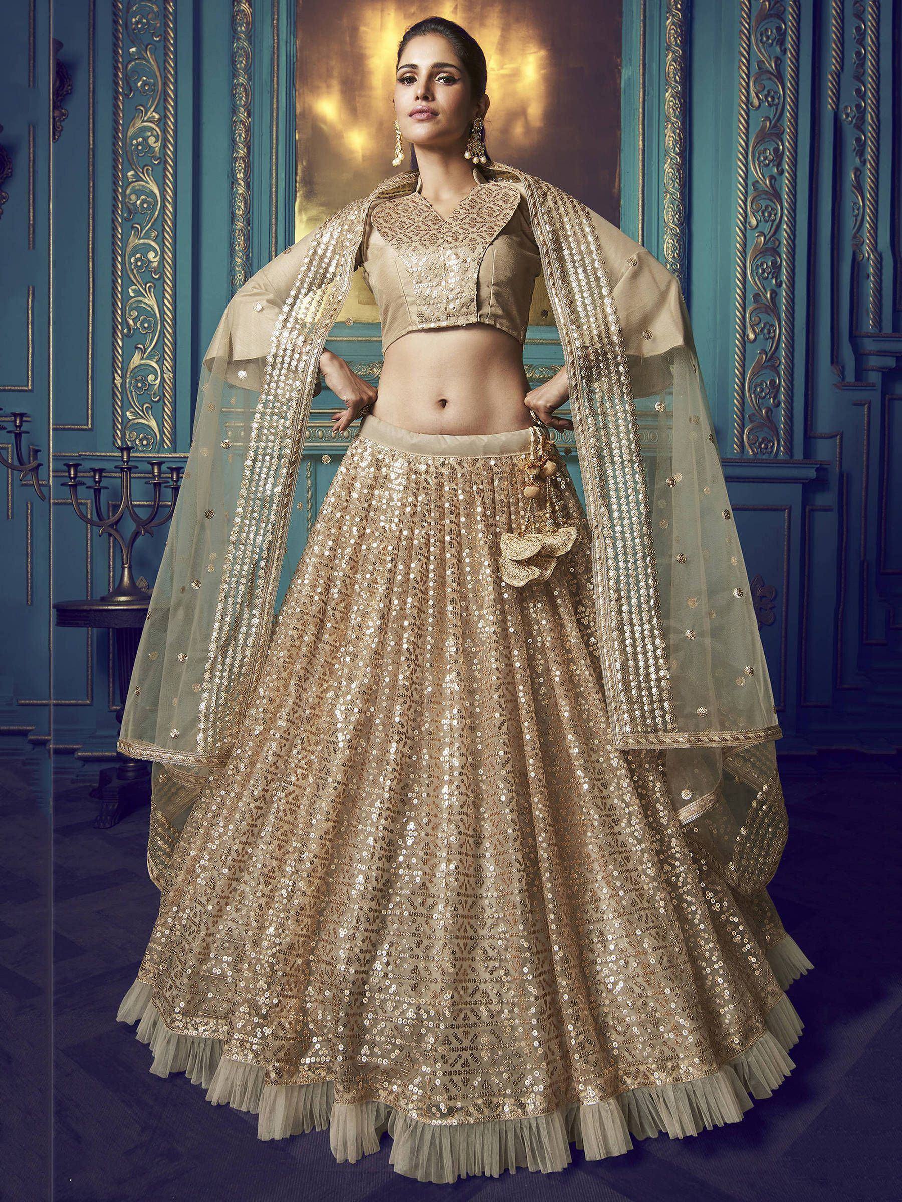 Elegant gold sequin lehenga choli with sheer dupatta, perfect for Indian weddings and festive occasions.