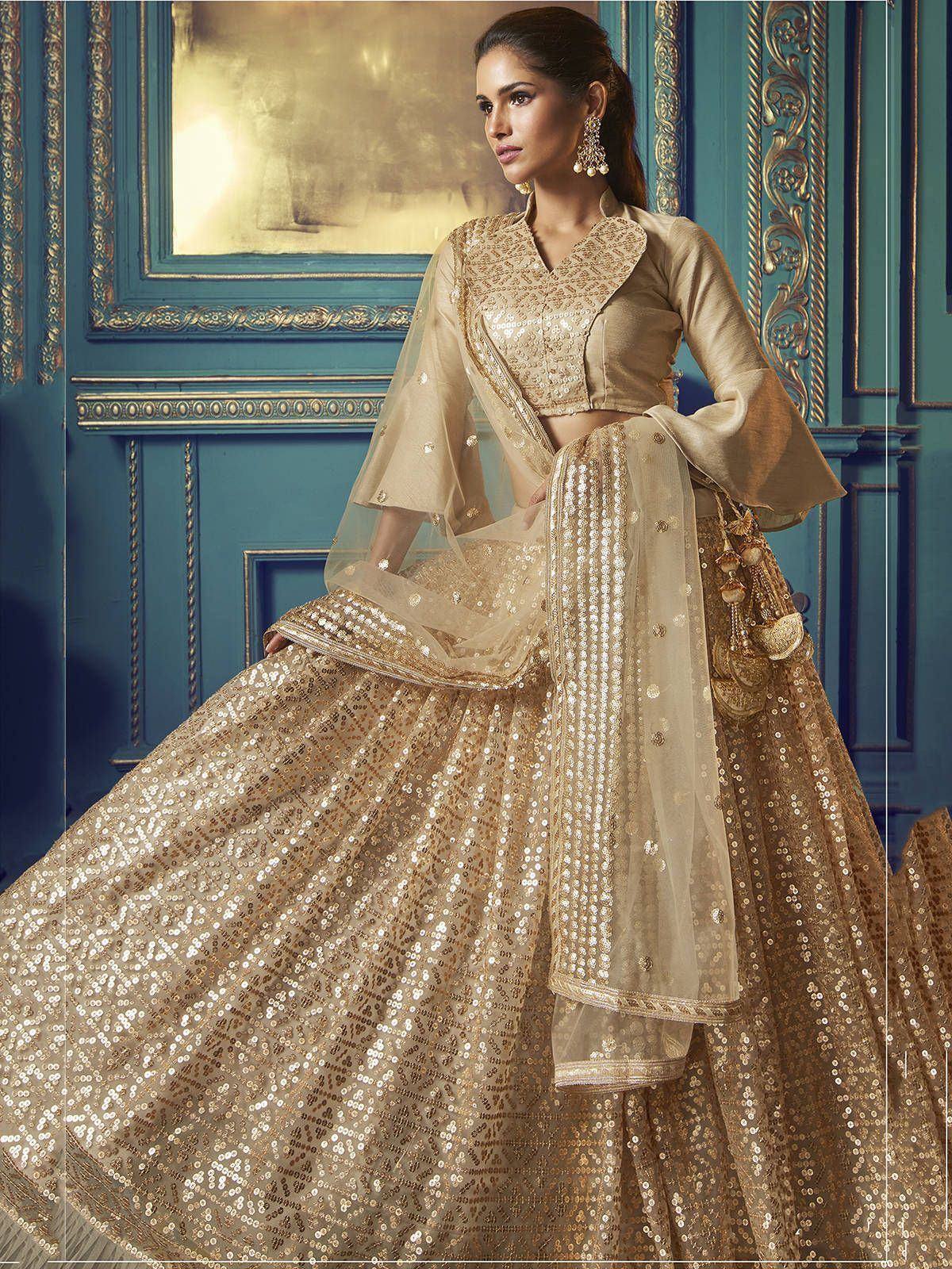 Elegant gold sequin lehenga choli with sheer dupatta, perfect for Indian weddings and festive occasions