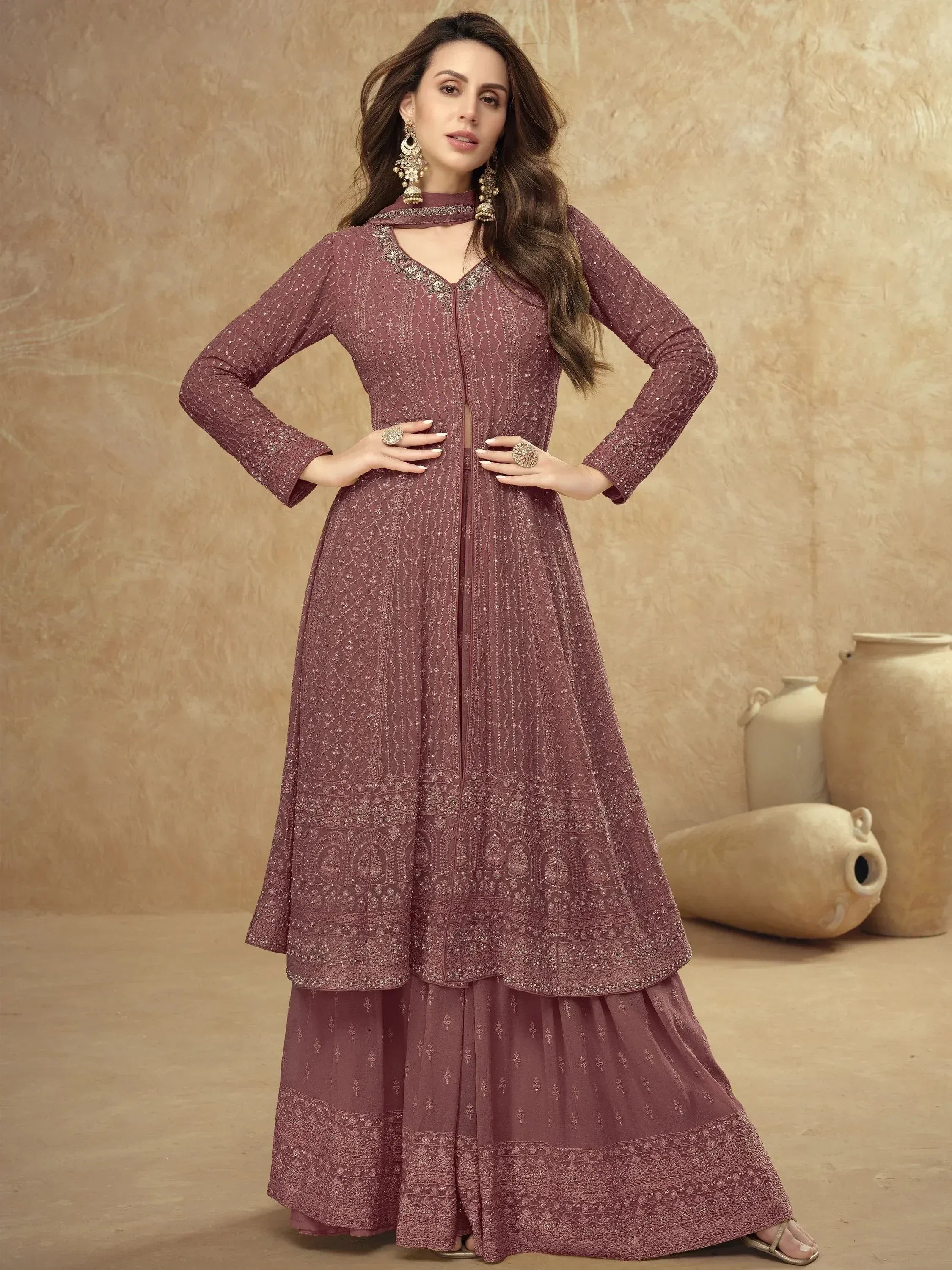 Elegant maroon ethnic gown with intricate embroidery and layered design for festive occasions