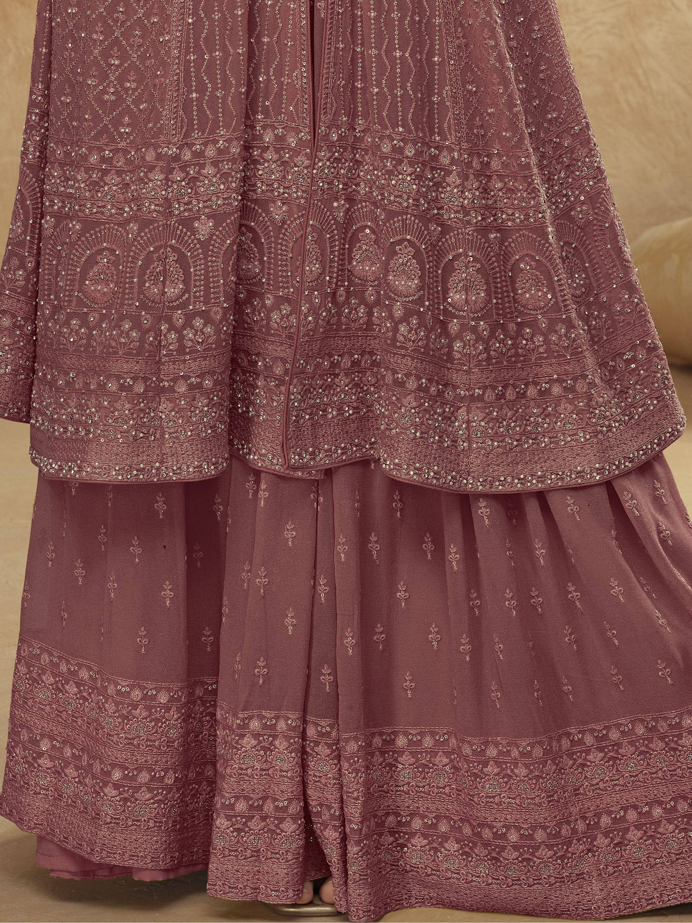 Elegant mauve ethnic gown with intricate embroidery and sequin detailing, perfect for festive occasions.