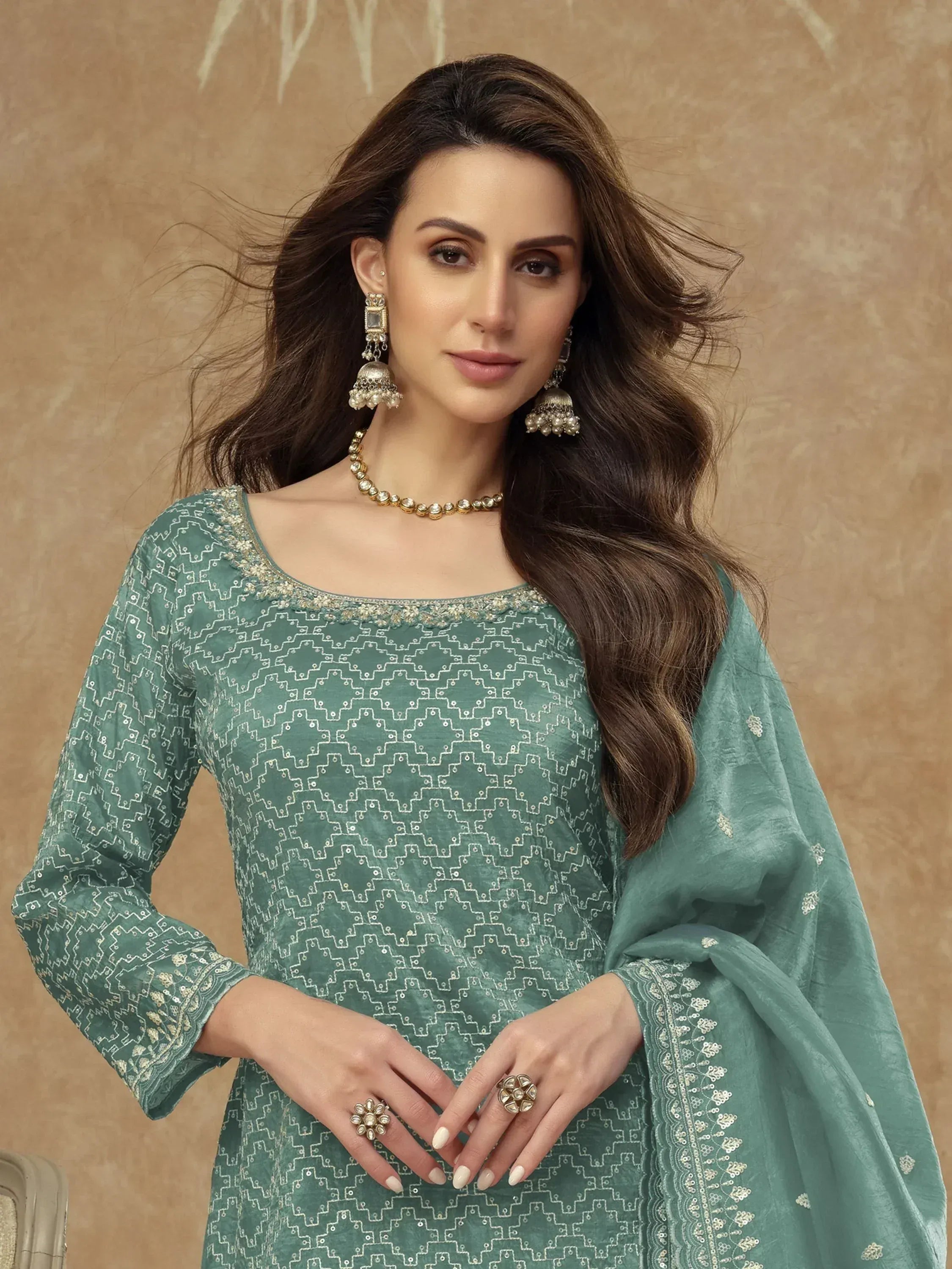 Elegant green embroidered salwar kameez with geometric patterns, perfect for Indian ethnic wear occasions.