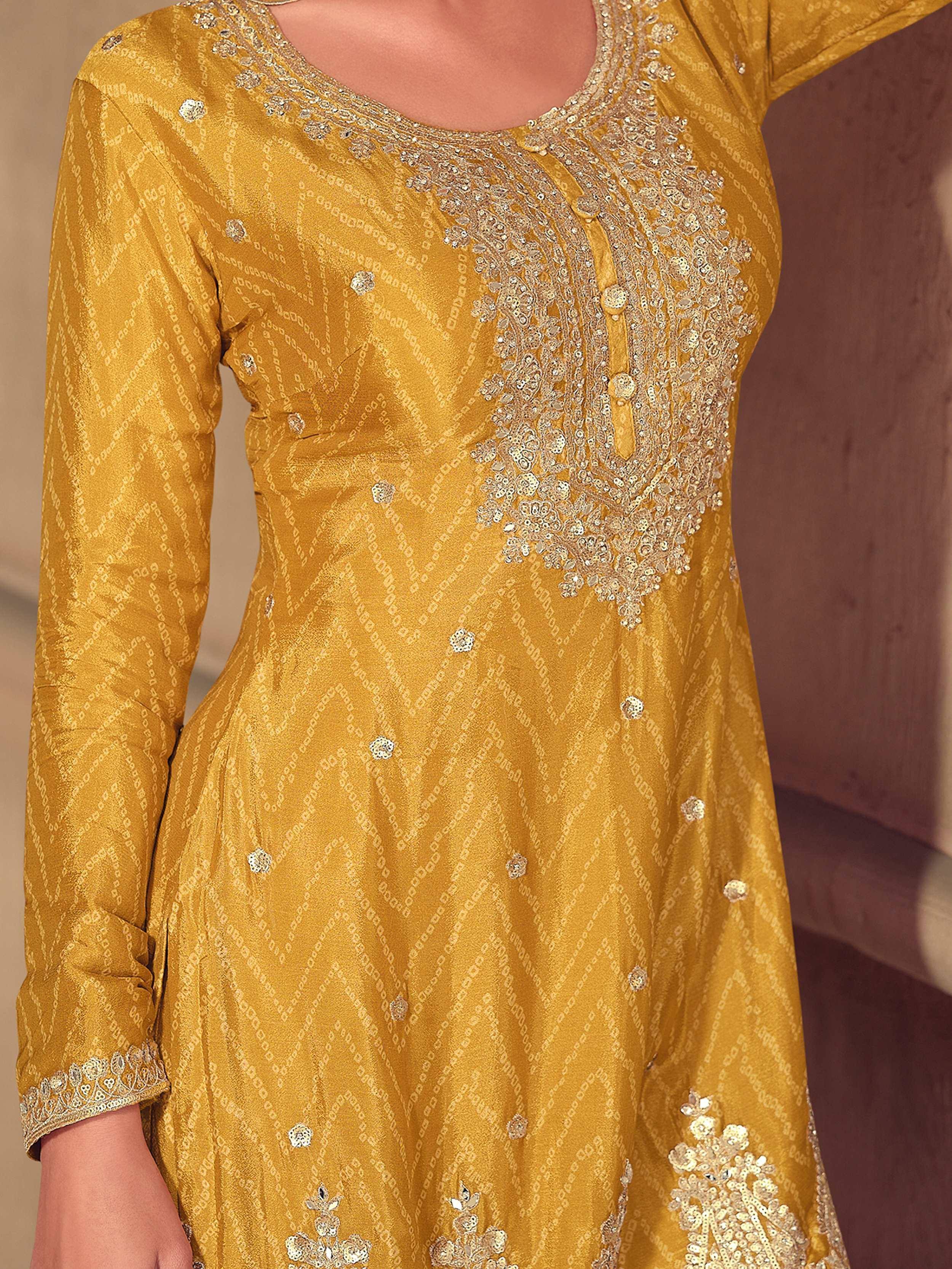 Mustard yellow ethnic kurti with intricate gold embroidery and sequin detailing for festive occasions