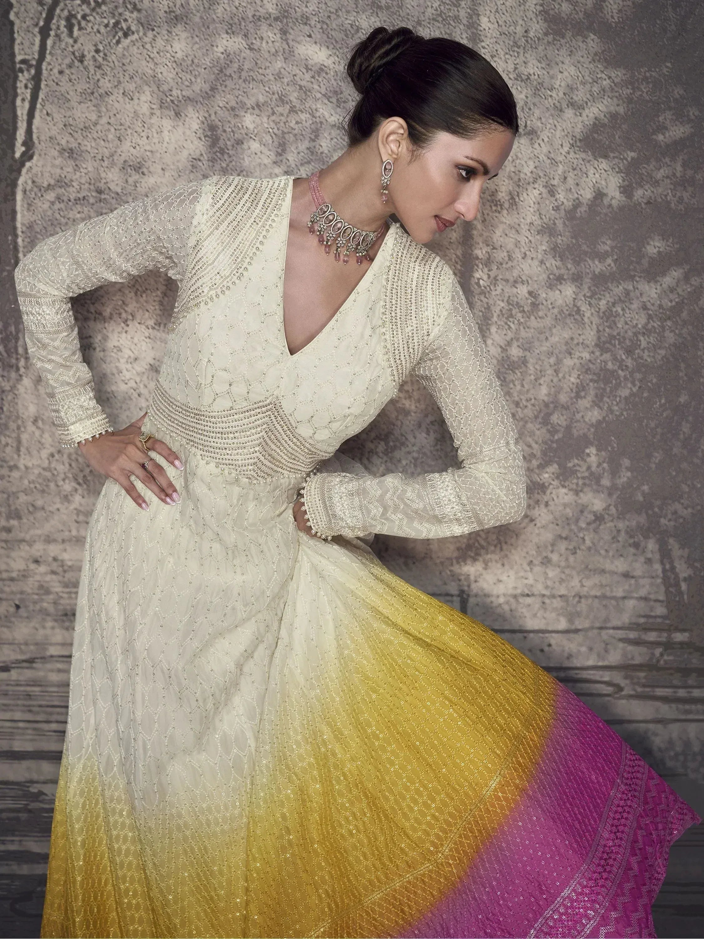 Elegant ivory to yellow pink ombre ethnic gown with intricate embroidery and sequins, perfect for Indian celebrations.