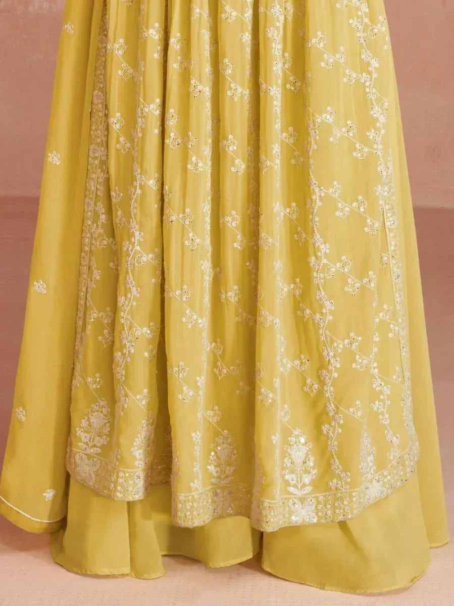 Yellow embroidered lehenga with white floral detailing and intricate border