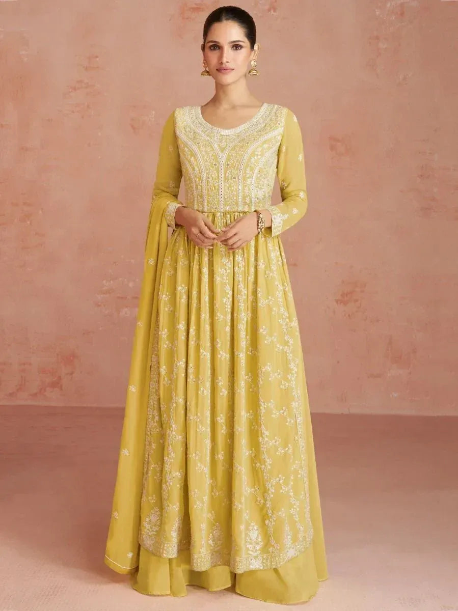 Woman wearing yellow embroidered Anarkali gown with long sleeves, ethnic Indian dress