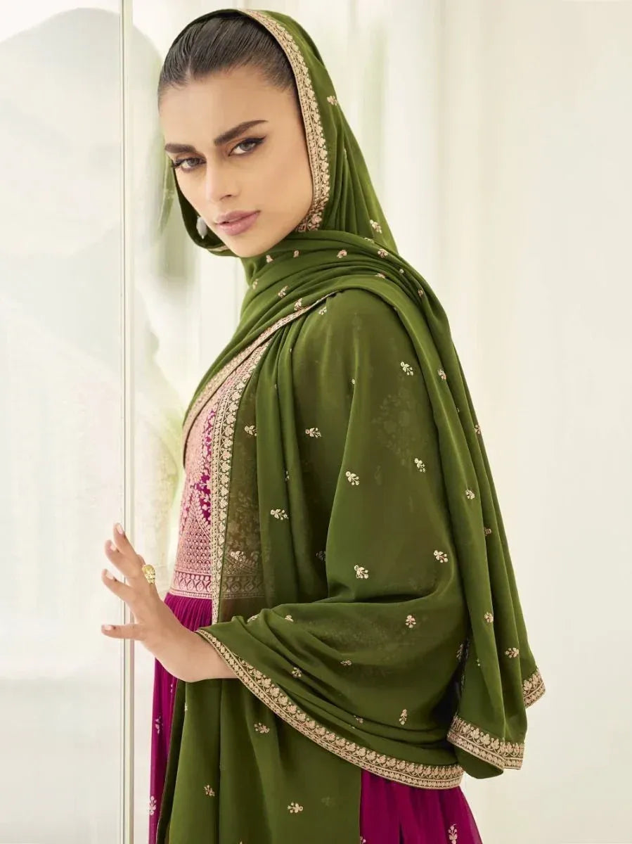 Woman in green embroidered dupatta and traditional Indian ethnic wear, posing indoors