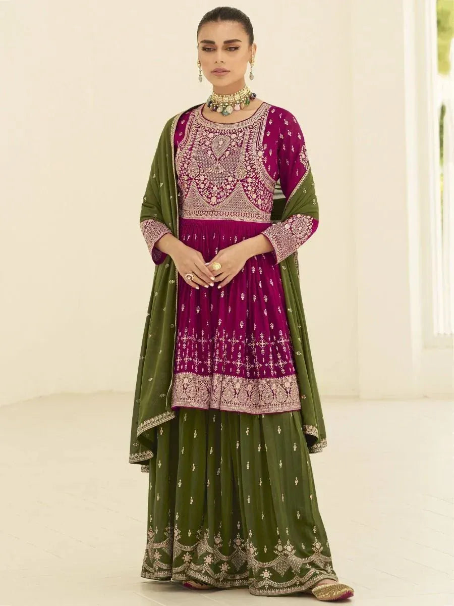 Woman wearing maroon and olive green embroidered ethnic gown with dupatta, styled for festive wear.
